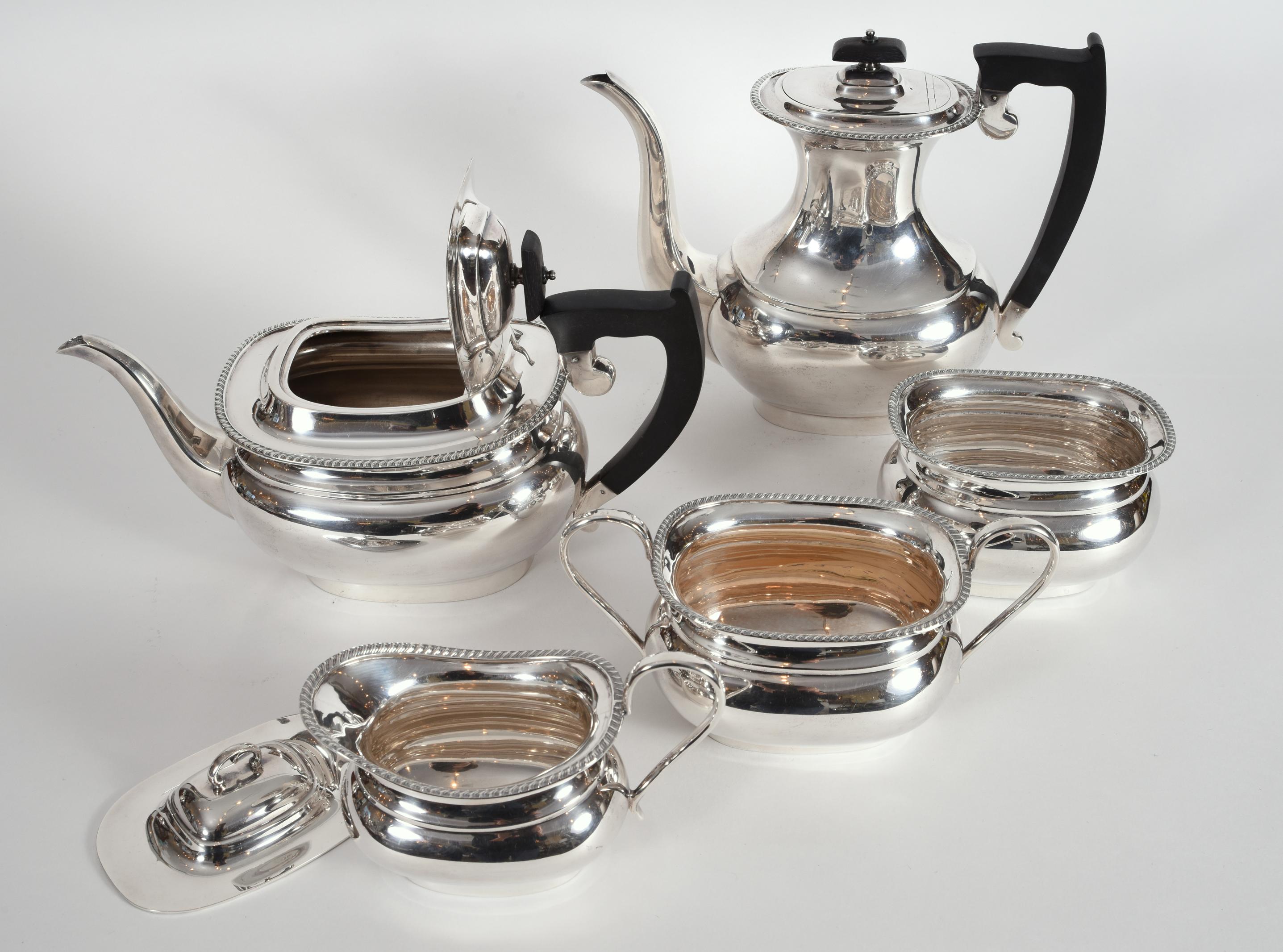 Vintage sterling silver English Sheffield five pieces tea and coffee service with black wood handle. Each piece is in excellent vintage condition, maker's mark undersigned. The sterling coffee pot is 10 inches diameter x 8.5 inches high. The