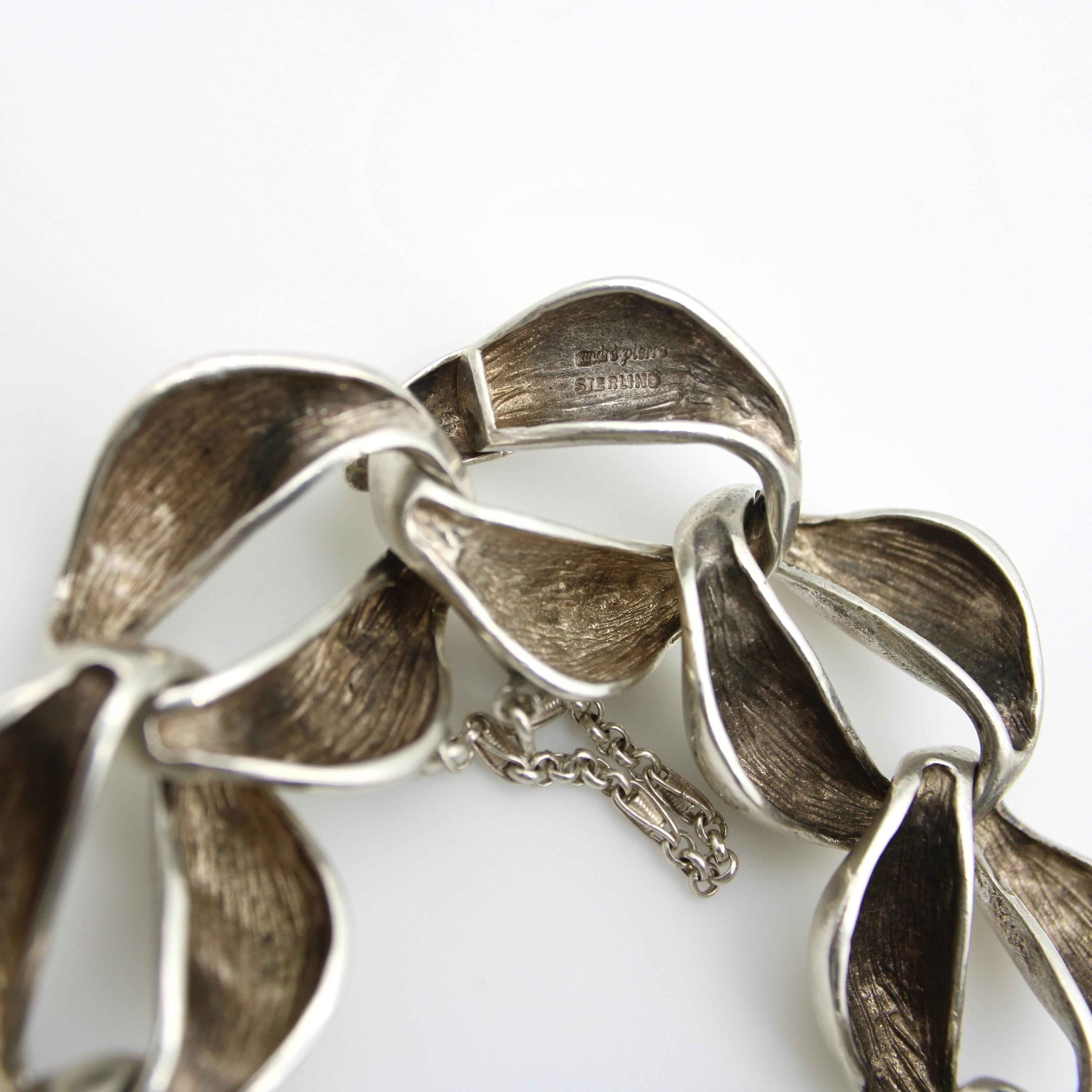This fabulous sterling silver bracelet consists of a giant curb link variation with a bold, chunky look. Each link has an organic form that undulates in and out of thickness creating a beautiful statement piece. The links are thick, but are hollow