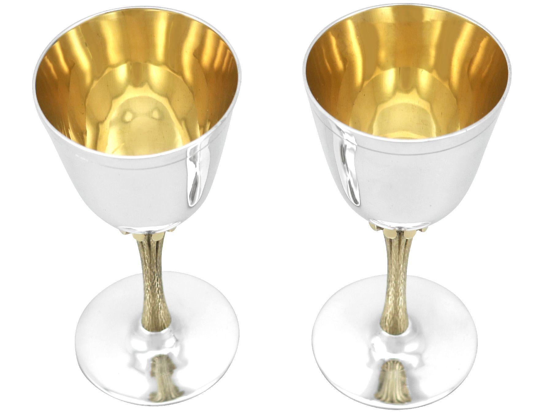 An exceptional, fine and impressive pair of vintage English sterling silver wine goblets; an addition to our collectable range of silverware.

These exceptional vintage sterling silver goblets have a plain bell shaped form to a naturalistic