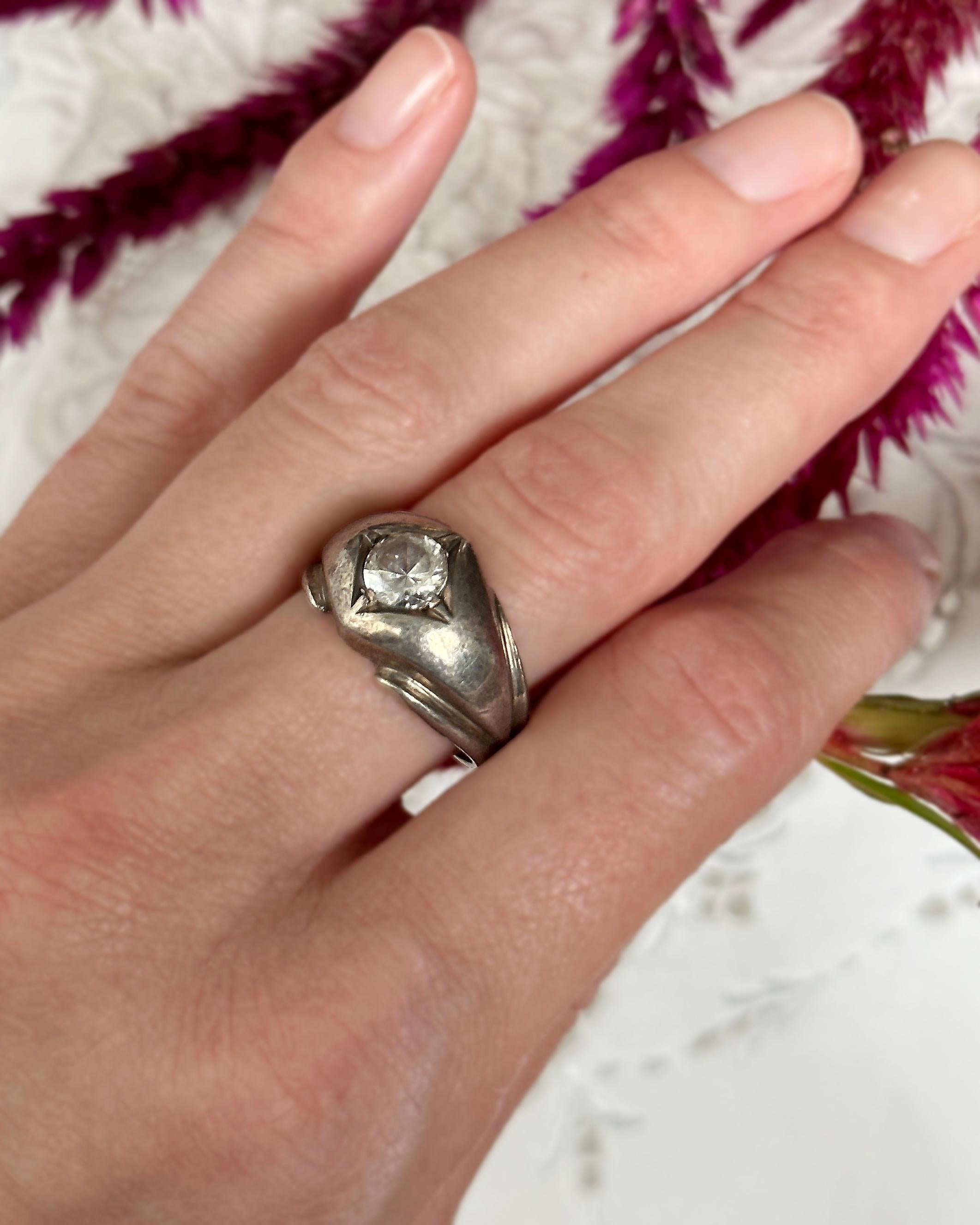 I adore flush-set / flush-mount rings, and this vintage ring is just perfect. It is crafted of sterling silver, and set with a single large crystal in a starburst setting. These rings became popular during the Victorian era; in an effort to conceal