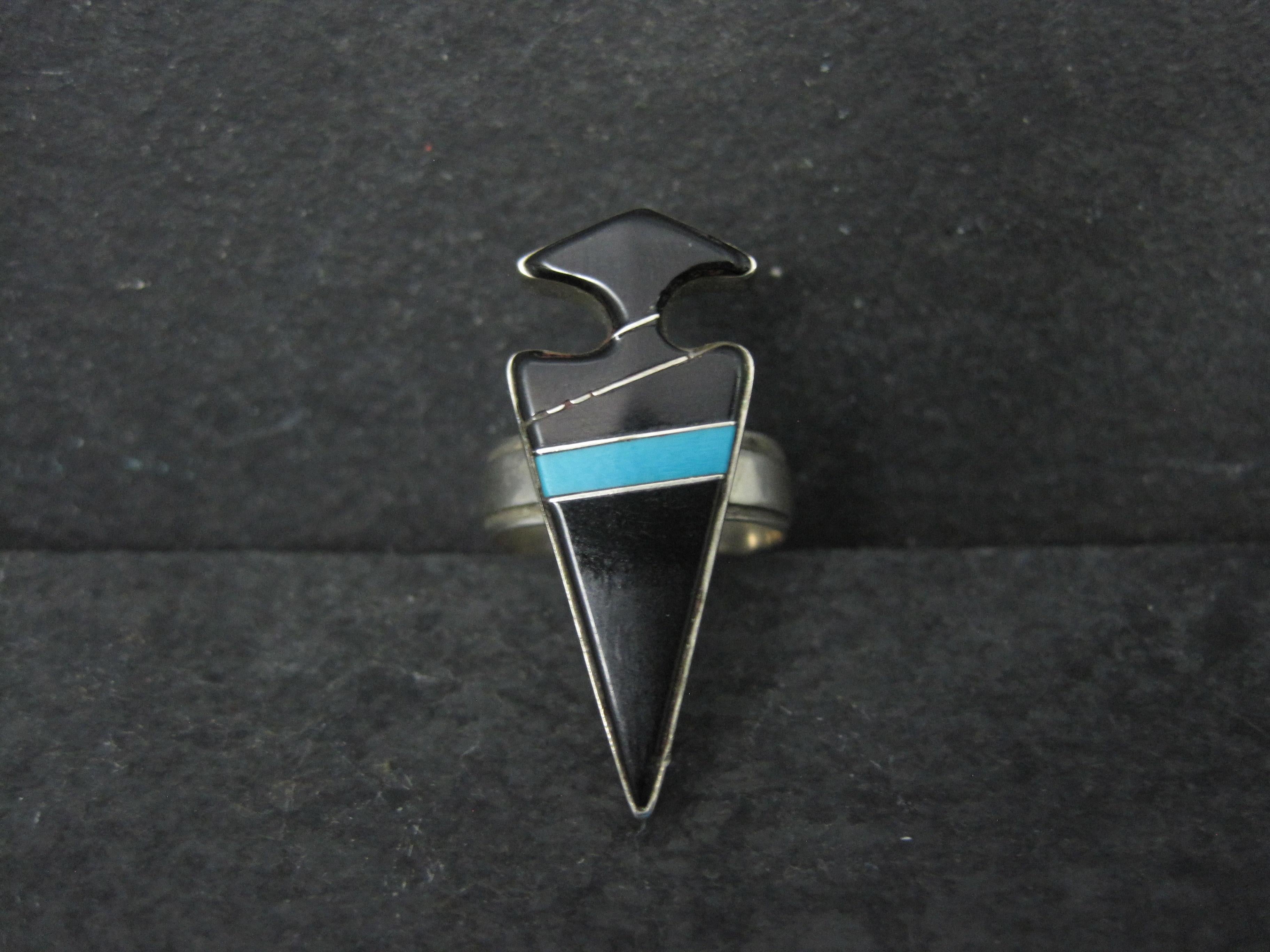 This gorgeous vintage Native American arrowhead ring is sterling silver.
It features a combination of jet and turquoise inlay.
The face of this ring measures 1 1/4 inches north to south.
Size: 6
Marks: BRB
Condition: Excellent