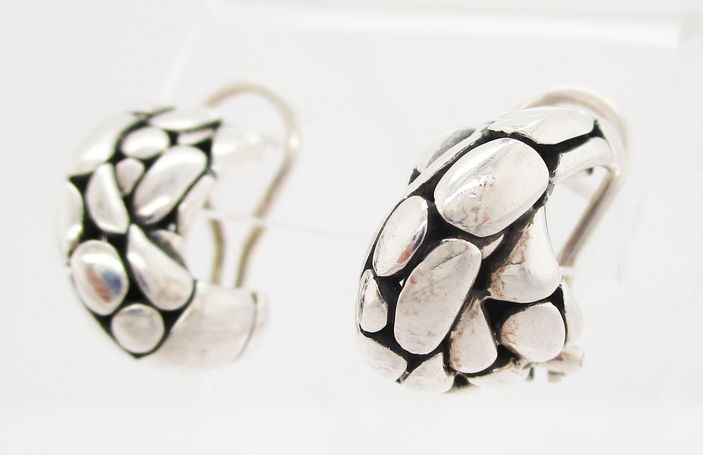 These are a gorgeous pair of vintage John Hardy earrings in sterling silver with a classic balonesian look. The twisted design makes these earrings comfortable, but the textured, dramatic black and silver look makes them impossible to miss! These