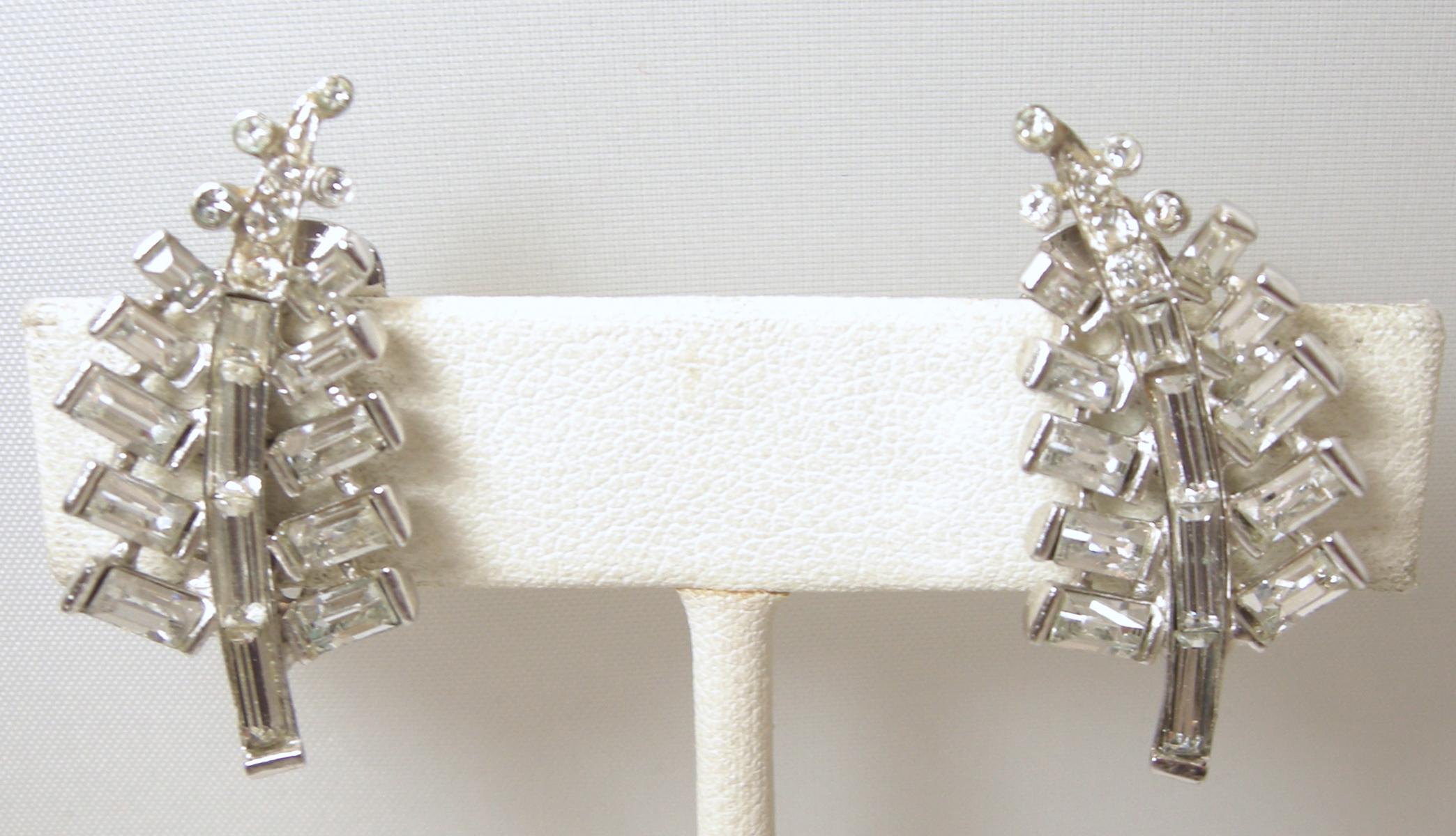 These beautiful vintage crystal clip earrings have a leaf design in a sterling silver setting. They are made with stunning baguette crystals. They measure 1-1/4” long x 5/8” wide.  They are signed “Sterling” and in excellent condition.