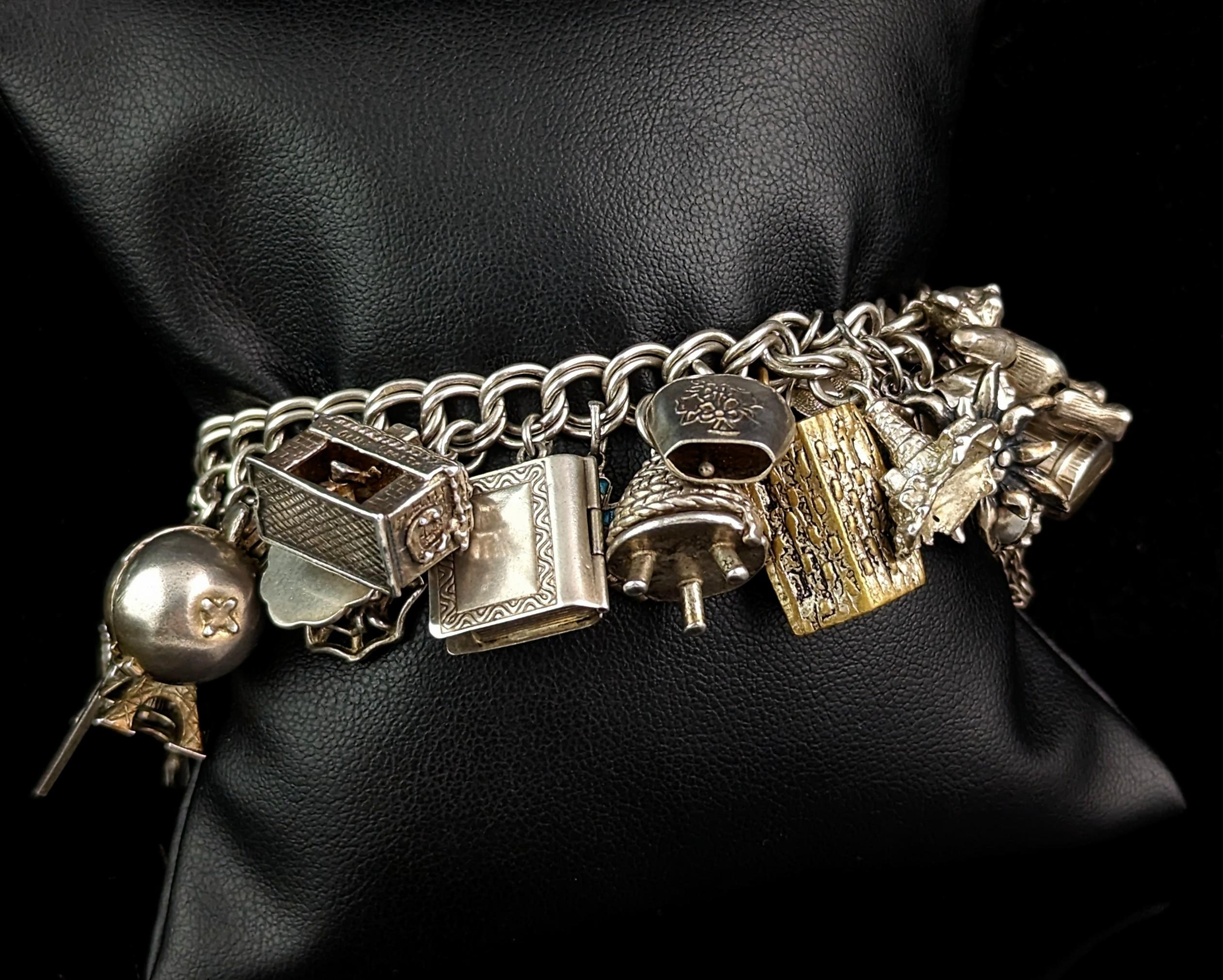 An outstanding vintage sterling silver charm bracelet loaded with silver charms.

This bracelet has been built upon over many years and boasts a really impressive and unique array of different charms.

It is built upon a chunky silver double curb