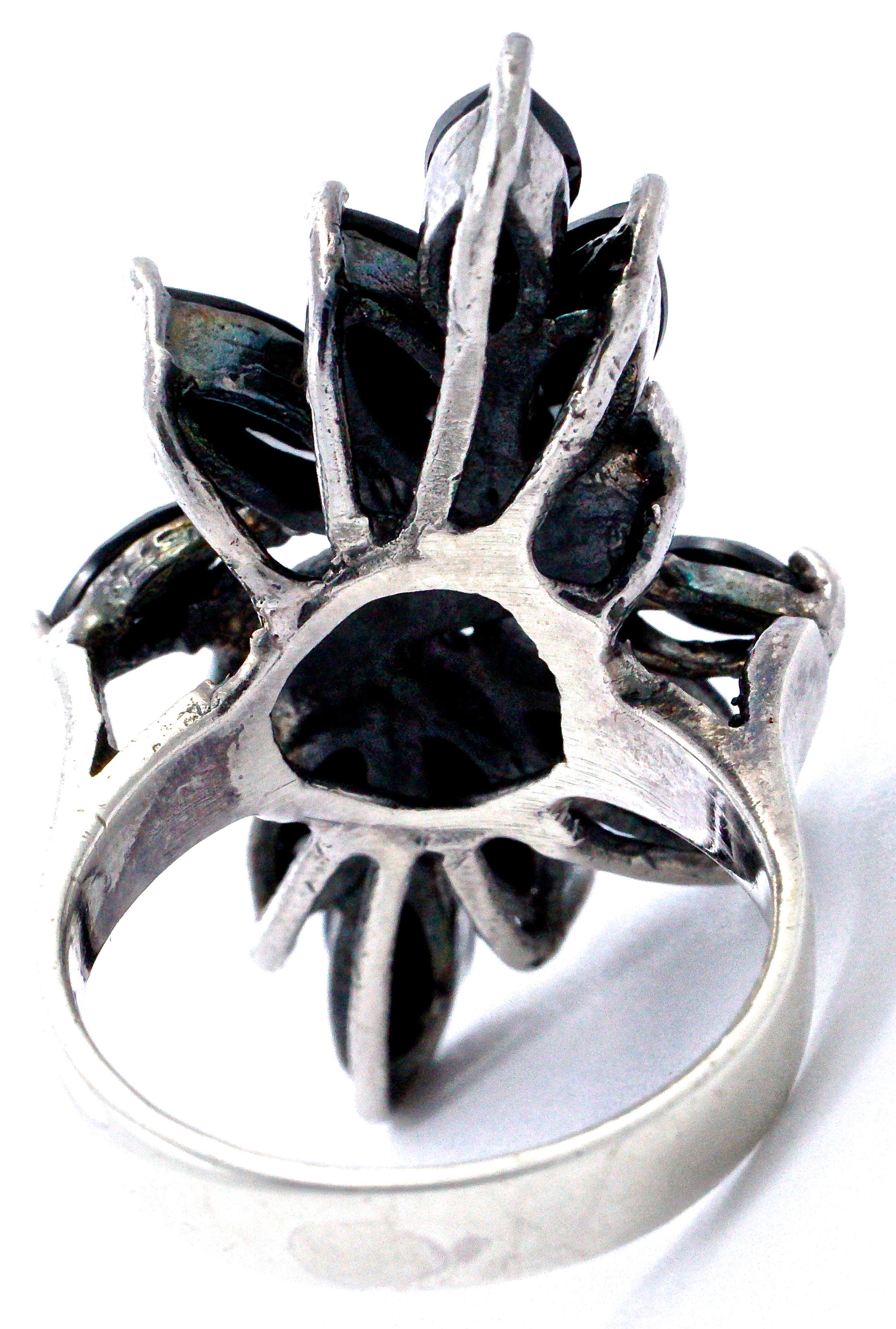 Stylish sterling silver ring featuring ten black glass marquise cut stones, divided by a row of marcasites with fancy edge decoration. The silver has some scratching, the black stones are in very good condition. Ring size UK M 1/2 / US 6 1/4, inside
