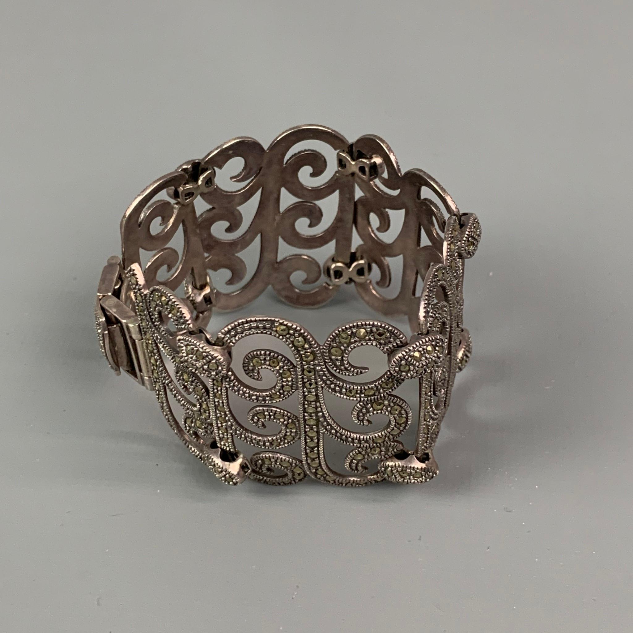 VINTAGE bracelet comes in a sterling silver featuring a marcasite link style with a clasp closure. 

Good Pre-Owned Condition.
Marked: 925

Measurements:

Length: 7.25 in.
Width: 1.5 in. 