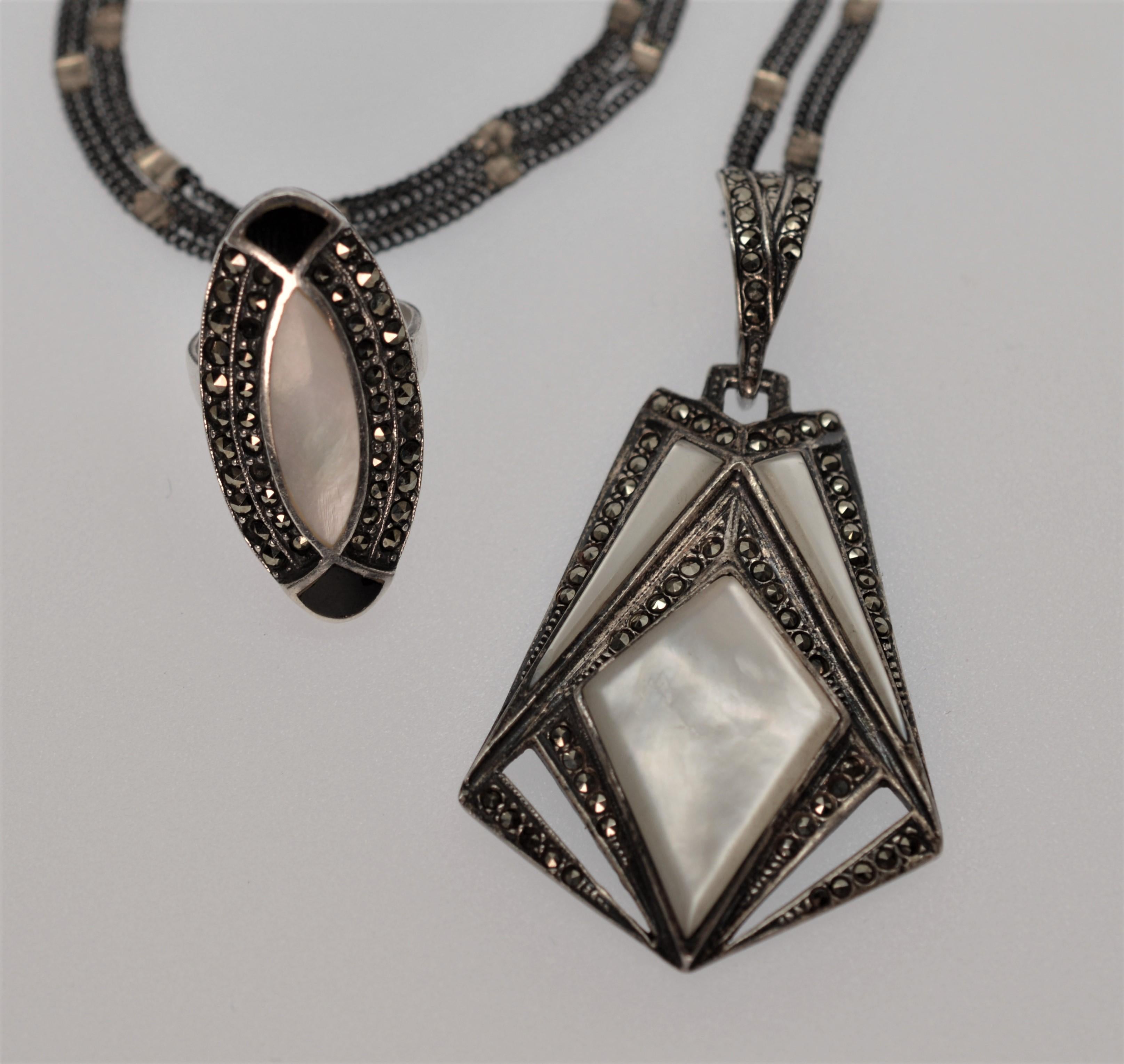 This Vintage Pendant Necklace and Ring will be a great addition to your collection!  Both pieces are artfully constructed of Sterling  Silver, Marcasite and Mother of Pearl and create a complimentary pairing together or worn singularly. 
The