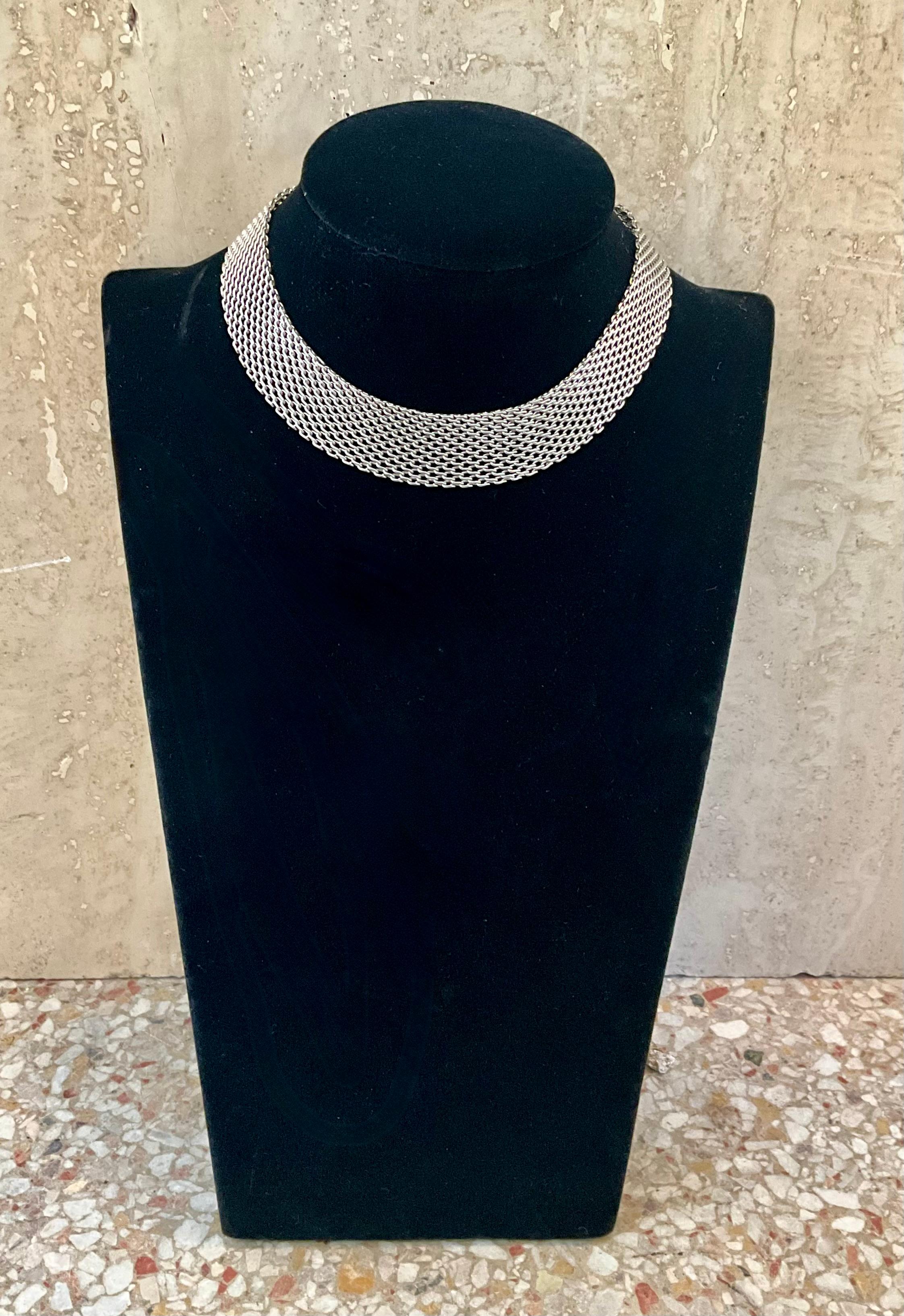 This Vintage Sterling Silver Mesh Necklace is an elegant and intricate piece of jewelry that showcases both craftsmanship and timeless style.

The defining feature of a mesh necklace is its woven or braided structure, which can resemble fine