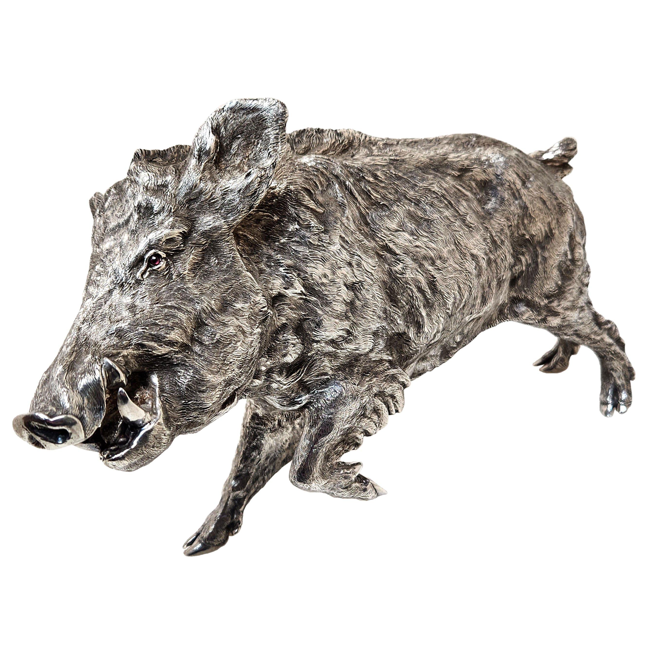 A magnificent Solid Silver Model of a Wild Boar crafted in Sterling Silver with a beautiful attention to details. The Silver Boar is of notably large size and of good weight. The Boar has glass eyes inset. 

Made in London, England in 1987 by
