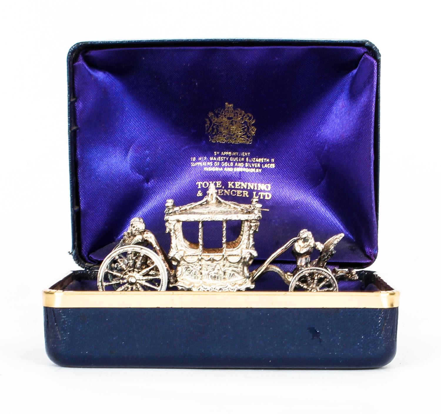 An attractive silver model of the Queen's coronation coach, hallmarked for Birmingham 1977, with the makers mark for Toye, Kenning & Spencer Ltd

In the original leatherbound case, with purple silk lining printed in gold with the maker, toye,