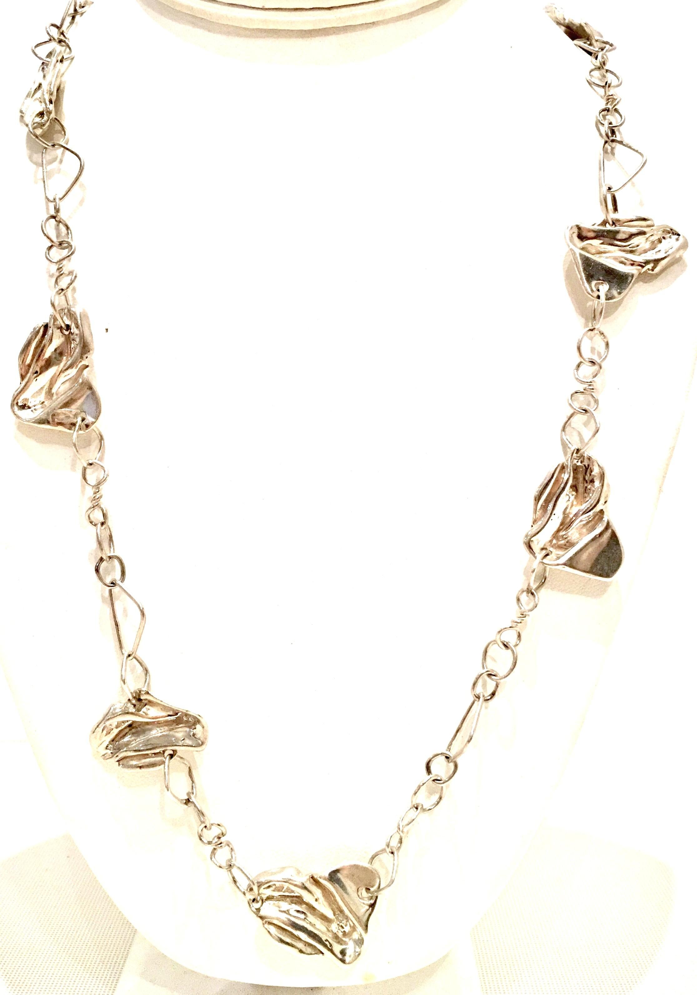 20th Century Sterling Silver Chain Link & Abstract Ornament Necklace. Features ten organic form dimensional ornaments on a chain link necklace. Each of the ten ornaments measure approximately 1