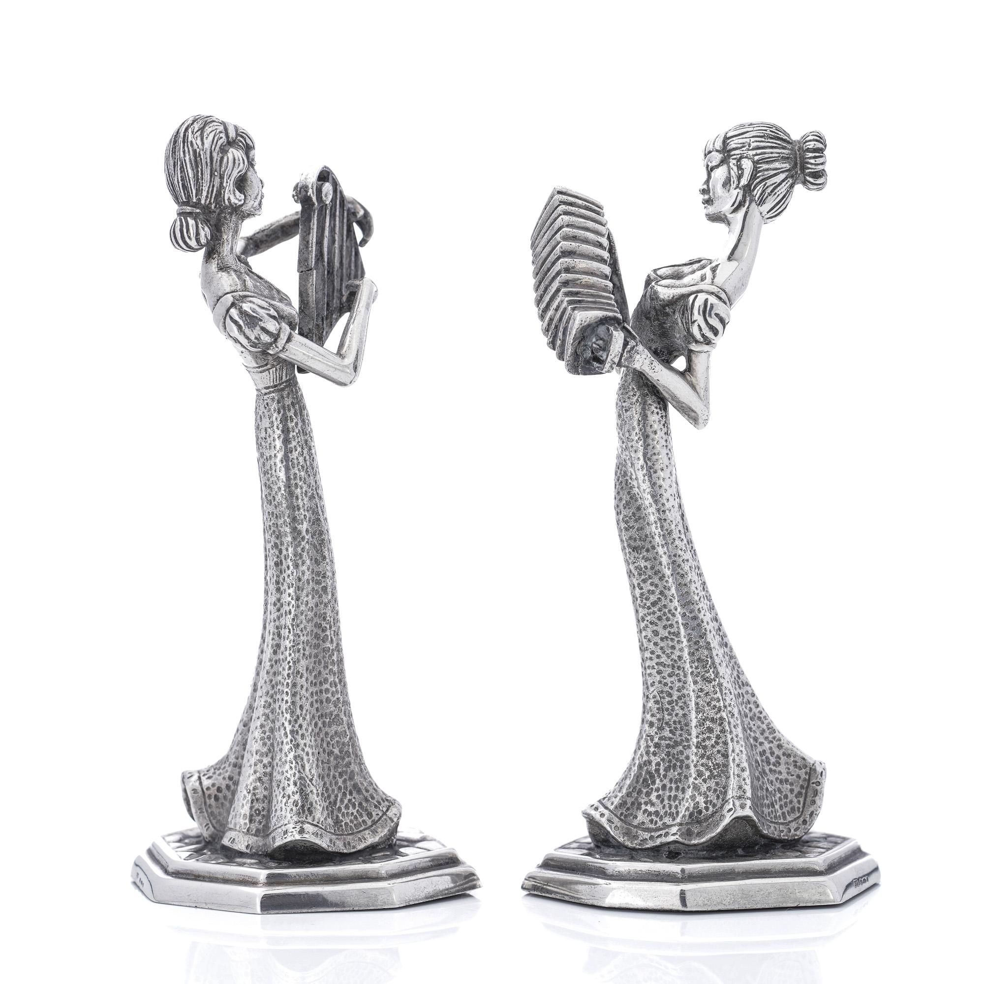 Vintage sterling silver pair of lady figurines by Mappin & Webb 
Made in England, 1973
Maker: Mappin & Webb 
Fully Hallmarked. 

Approx. Dimensions - 
Length x Width x height: 6.4 x 4.9 x 13.5 cm 
Weight: 365 grams in total. 

 Condition: