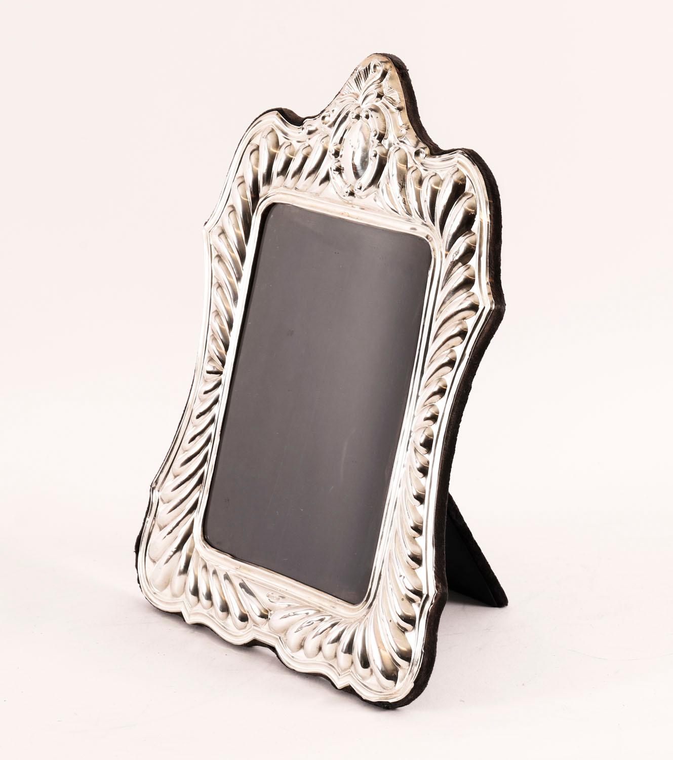 A superb large vintage hallmarked sterling silver photograph frame with hallmarks for  Sheffield 1988.

This beautiful high quality portrait  frame has a decorative  fluted border  crested by a vacant C-scroll cartouche and a velvet lined easel