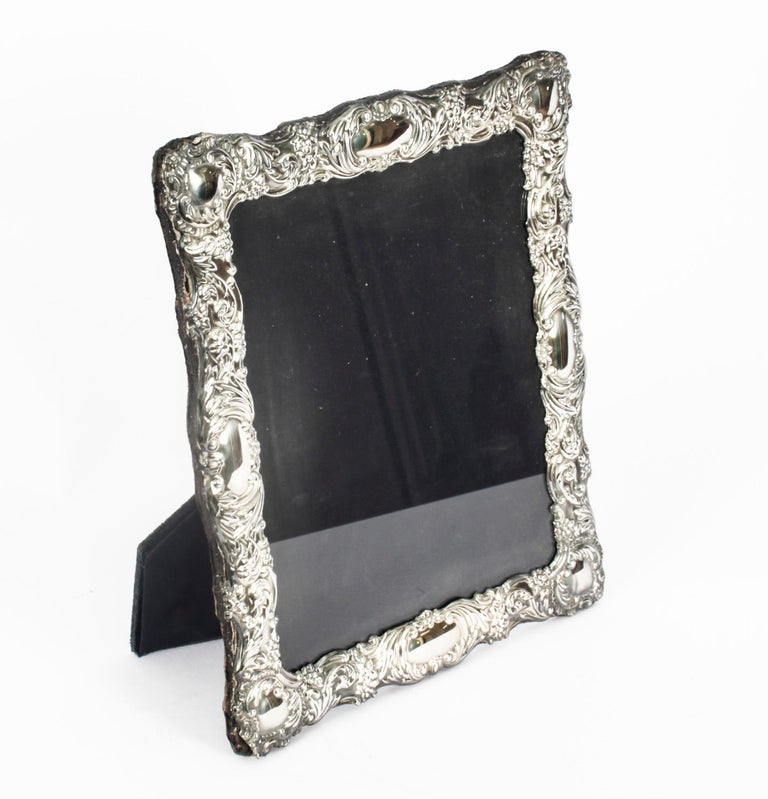 A truly superb large decorative sterling silver photo frame Carrs of Sheffield with the date marks for 1997.

The frame is beautifully decorated with floral and scroll relief borders and can be used landscape or portrait.

An excellent gift idea