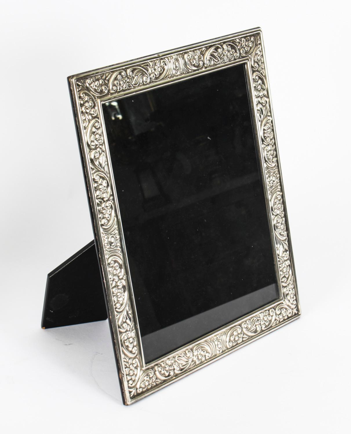 A truly superb large decorative sterling silver photo frame Carrs of Sheffield with the date marks for 1997.

Beautifully decorated with floral and scroll relief borders and with an ebonised wooden back.

An excellent gift idea for many