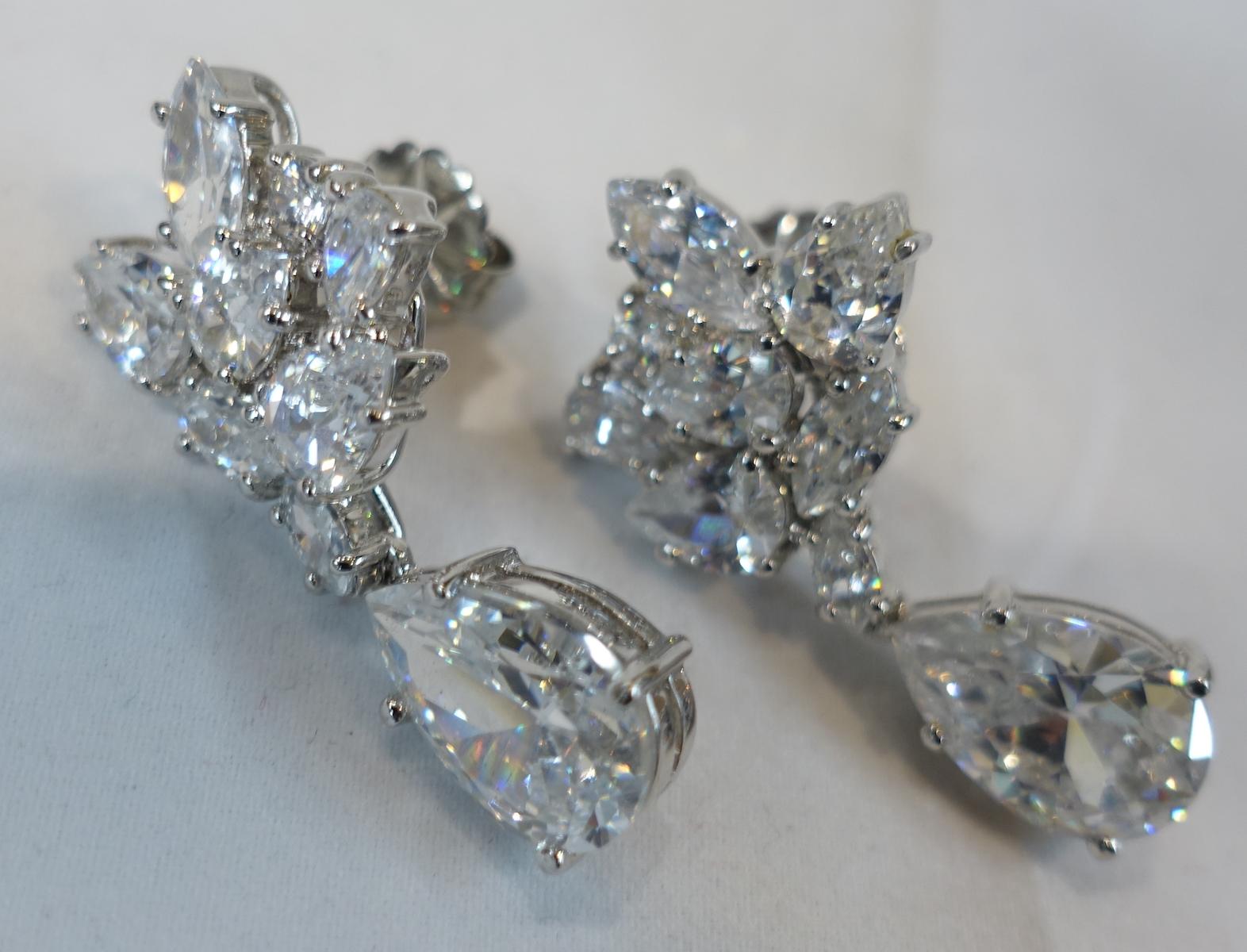 These vintage earrings have a crystal floral top with a clear crystal drop … in a sterling silver setting.  In excellent condition, these sterling silver pierced earrings measure 1-1/2” x 3/4”.