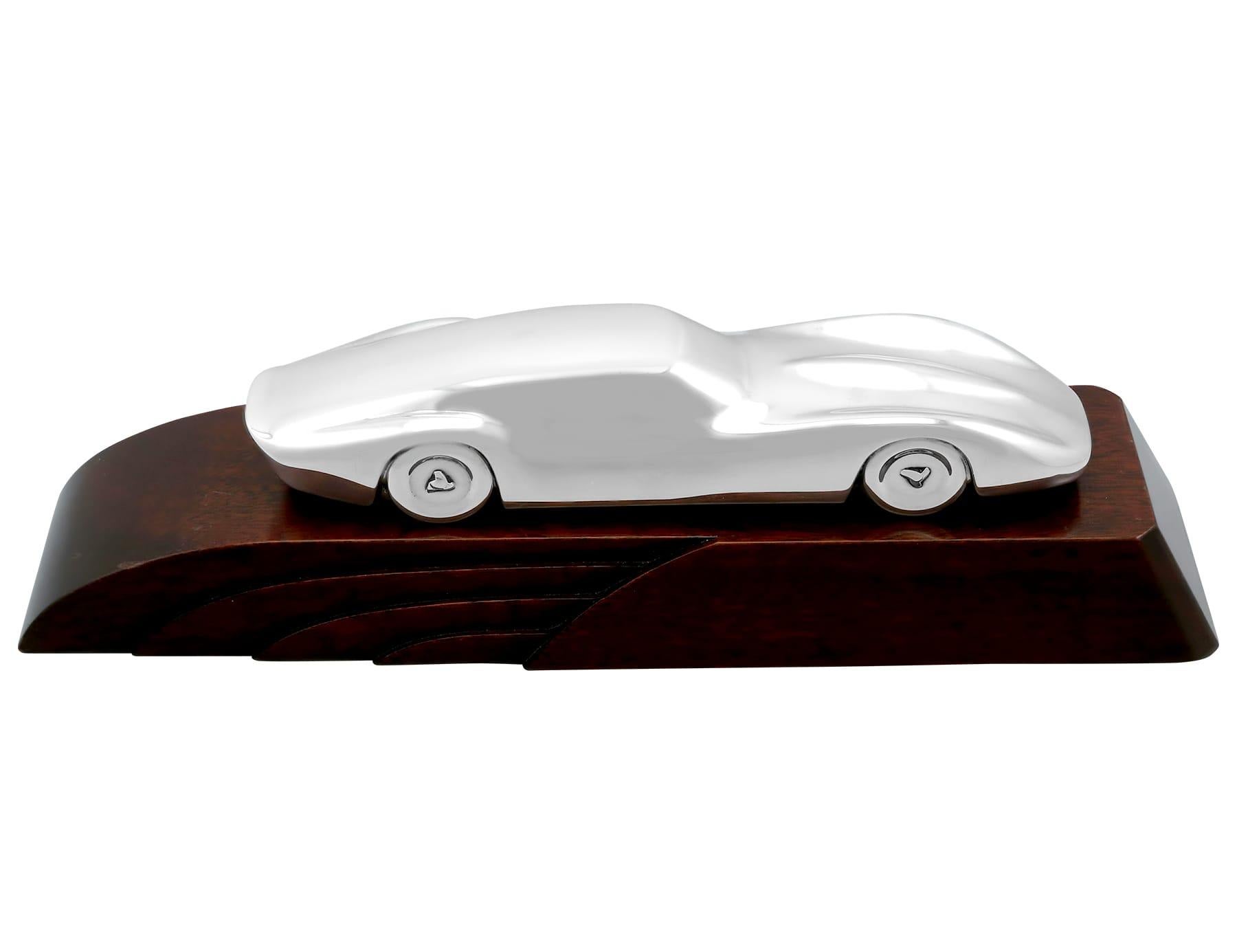 This exceptional and rare, vintage English sterling silver presentation ornament has been realistically modelled in the form of a car in the Art Nouveau manner.

The body of this stylised Jaguar style car has a plain moulded form.

This exceptional
