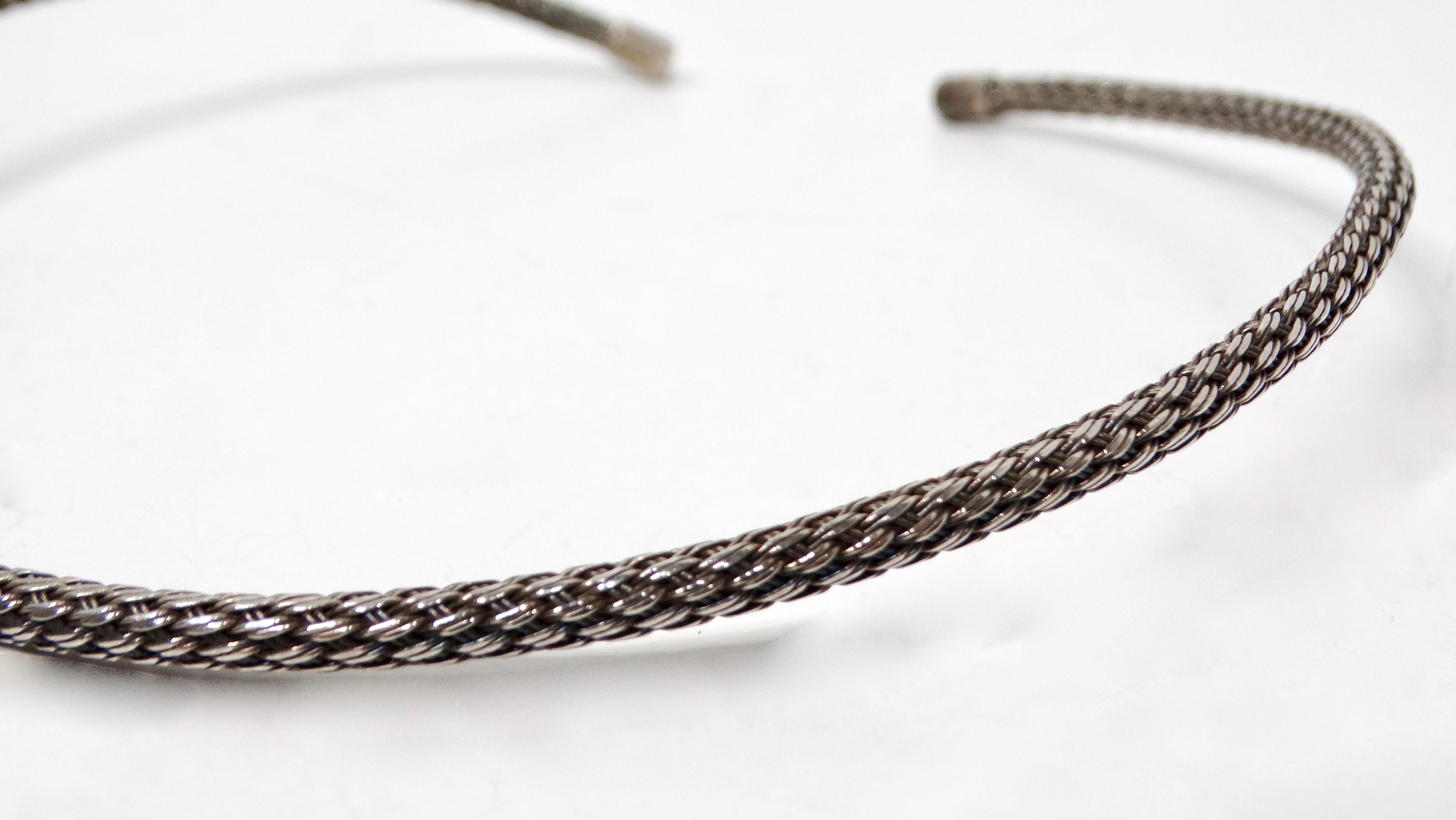 The Vintage Sterling Silver Rope Chain Choker Necklace is a timeless accessory that combines elegance and versatility. This exquisite piece features a unique design that is both stiff and bendable, allowing for a comfortable fit around the neck. The