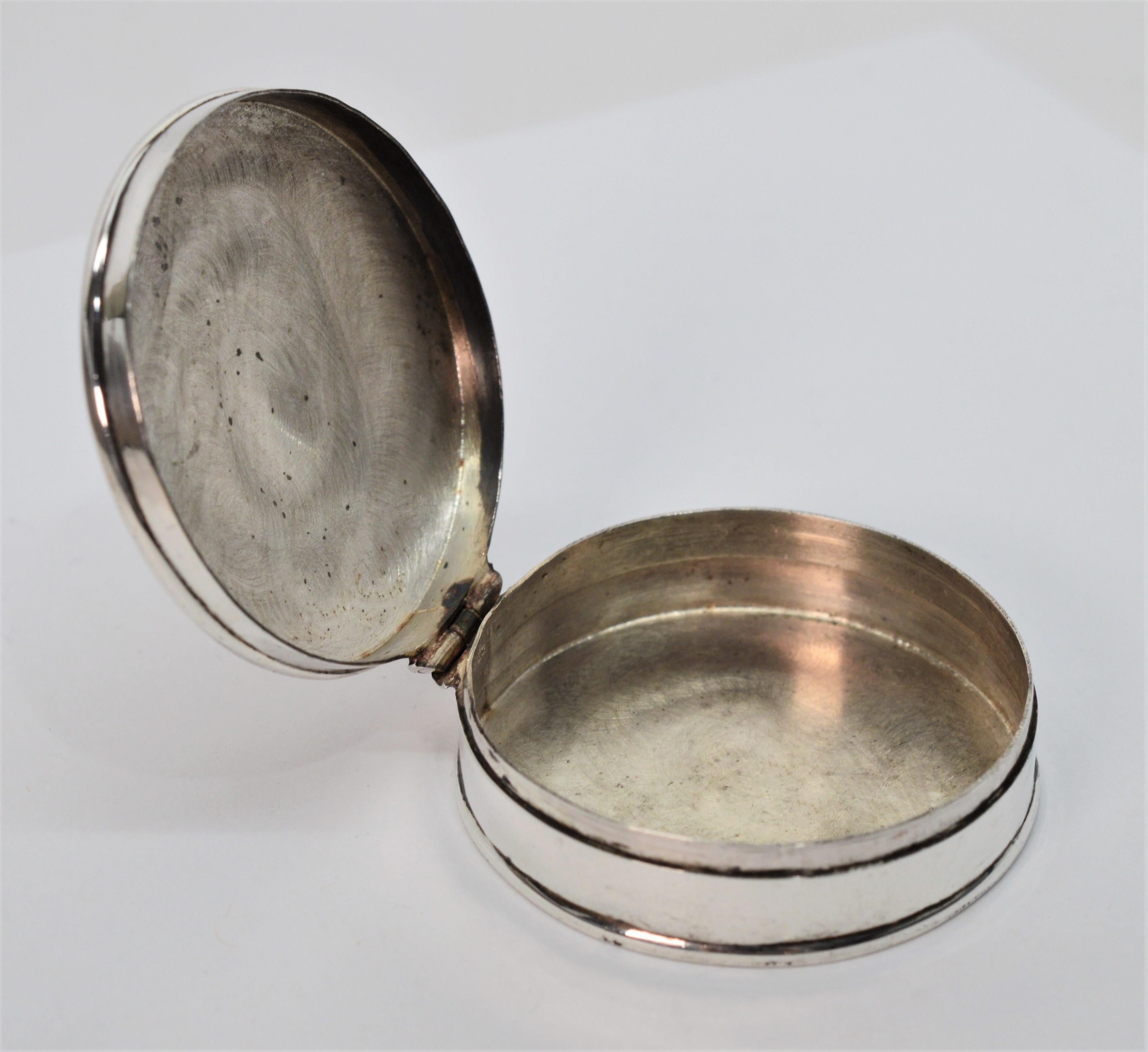 Distinctive and personal, carry your accoutrements in sterling silver finery. This pocket or purse size vintage round .925 silver box measures approximately 1-7/8 inch in diameter and 1/2 inch tall. It's beautifully engraved lid is hinged and holds