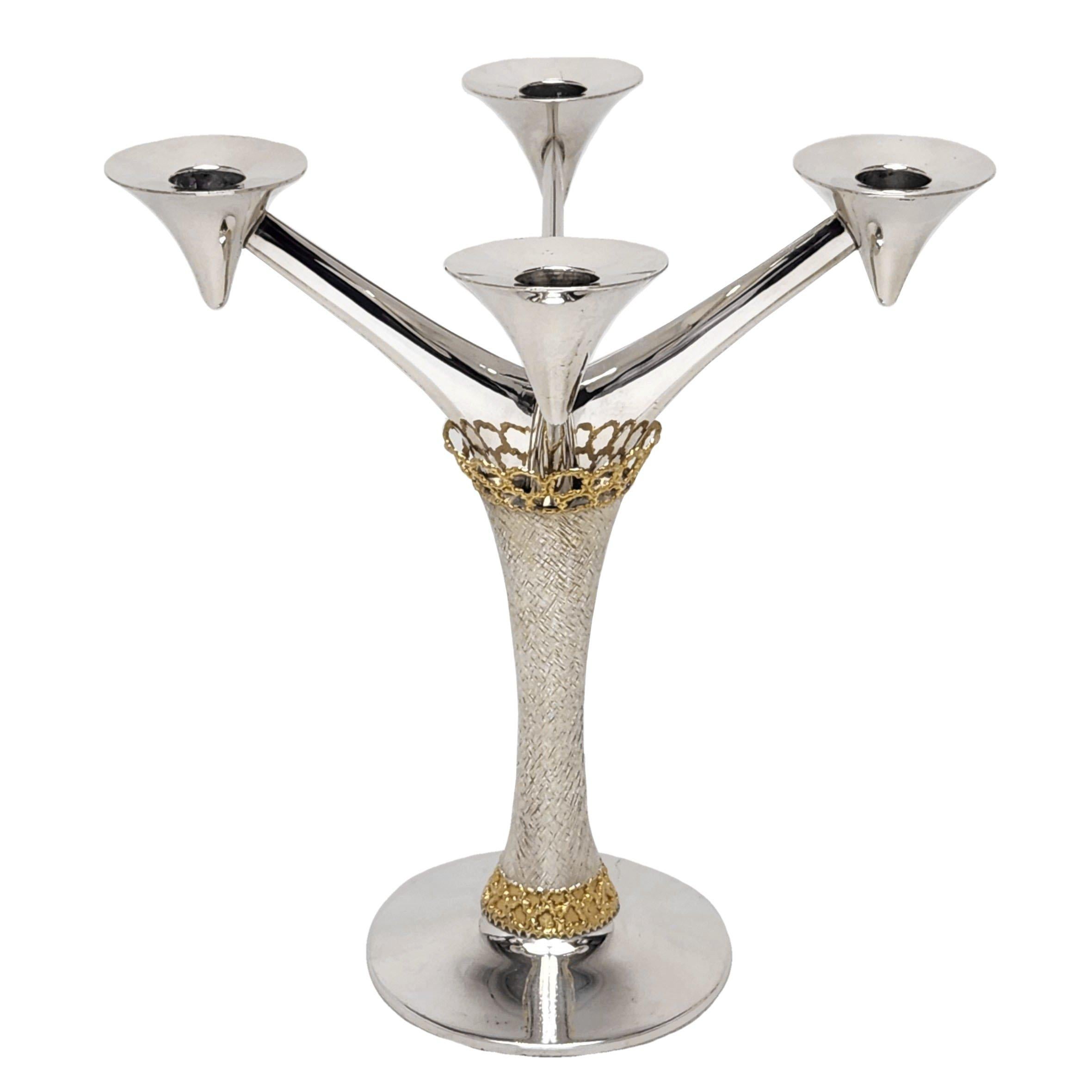 An elegant modernist Candelabrum by the esteemed Silversmith Stuart Devlin. The Four Light Candelabra has polished silver arms and base and a textured column embellished with the traditional Devlin parcel gilding at the capital and base.

Made in