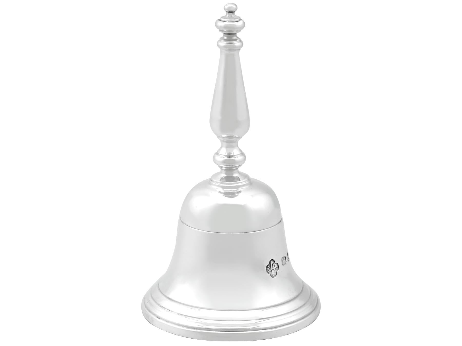 An exceptional, fine and impressive vintage English sterling silver table bell made by Asprey & Co Ltd; an addition to our range of ornamental silverware

This exceptional vintage Elizabeth II sterling silver table bell has a plain bell shaped