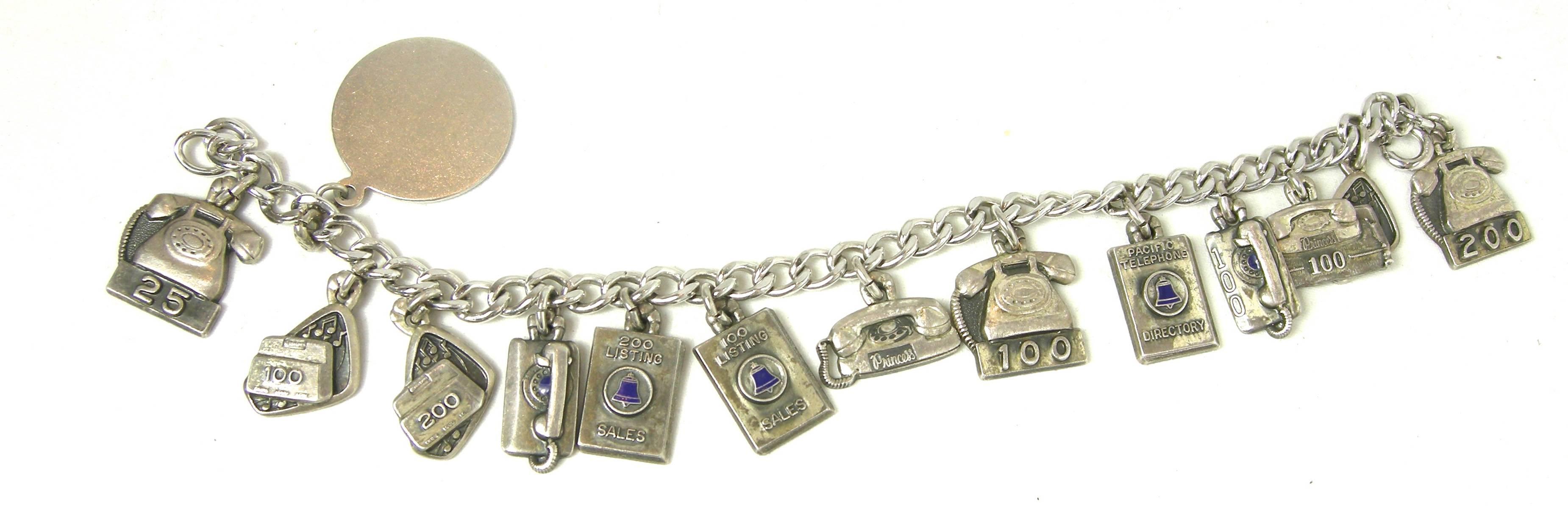 This is a rare collection of silver charms that had to take many years to put together.  The bracelet has a sterling silver open link chain with 13 sterling silver telephone charms.  Each phone depicts different a different time period when these