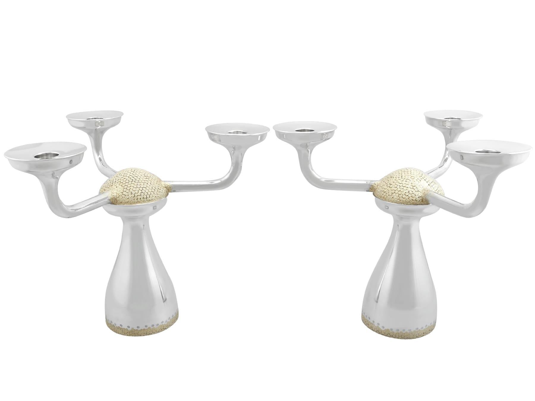A magnificent, fine and impressive pair of vintage Elizabeth II English parcel gilt sterling silver three light candelabra; an addition to our ornamental silverware collection.

These magnificent vintage Elizabeth II sterling silver candelabra have