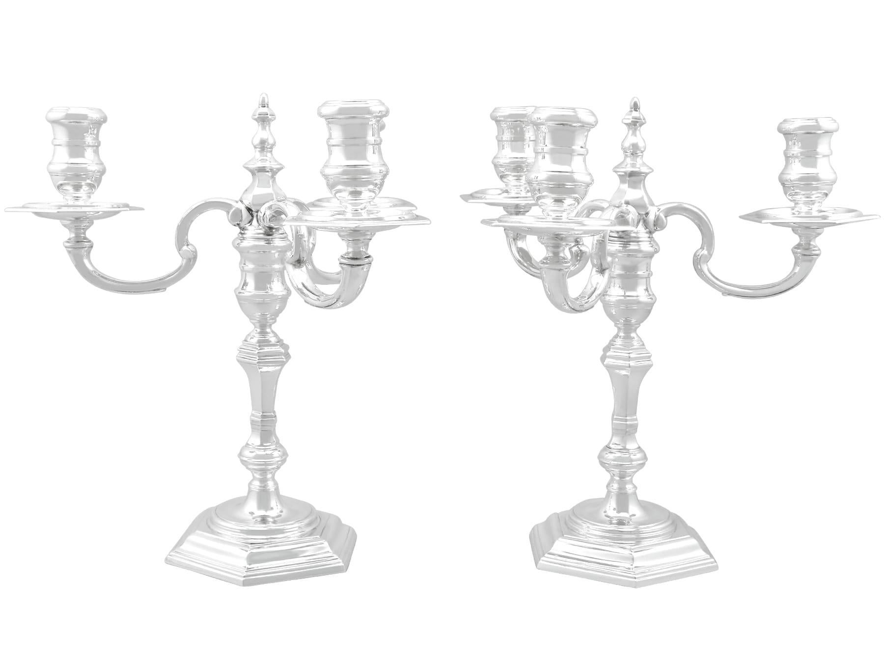 An exceptional, fine and impressive pair of vintage Elizabeth II English sterling silver three light candelabra; an addition to our ornamental silverware collection.

These fine vintage Elizabeth II sterling silver candelabra have a panelled