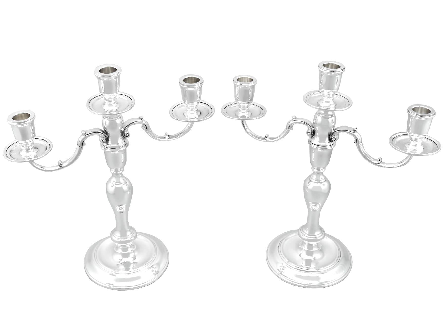 An exceptional, fine and impressive pair of vintage Elizabeth II English sterling silver three light candelabra; an addition to our ornamental silverware collection

These exceptional vintage silver candelabra, in sterling standard, have a