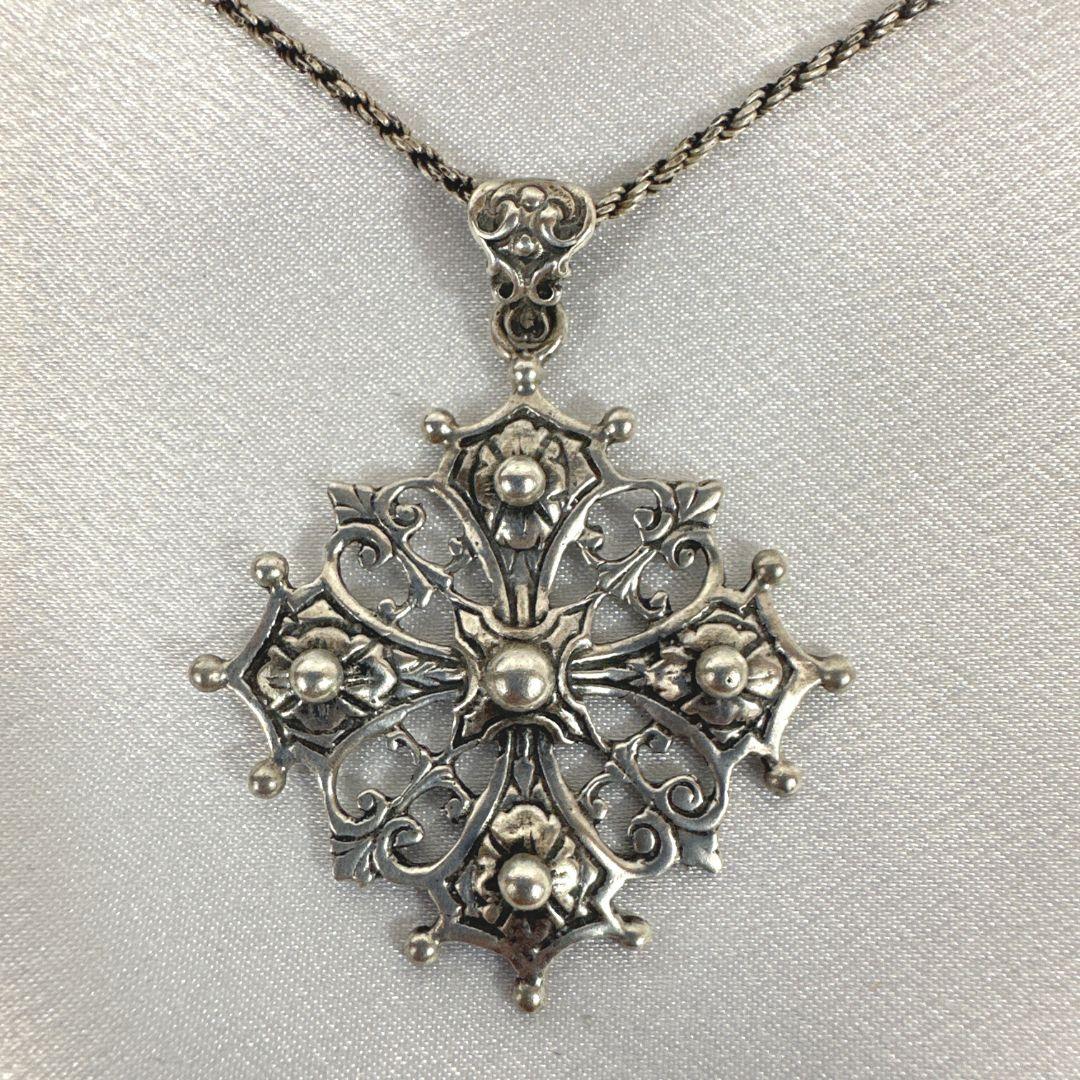 Elevate your faith with a touch of vintage charm with this Vintage Sterling Silver Unique Cross Pendant Necklace—a testament to both timeless craftsmanship and spiritual devotion. The delicate yet sturdy chain boasts a length of 20 inches, providing