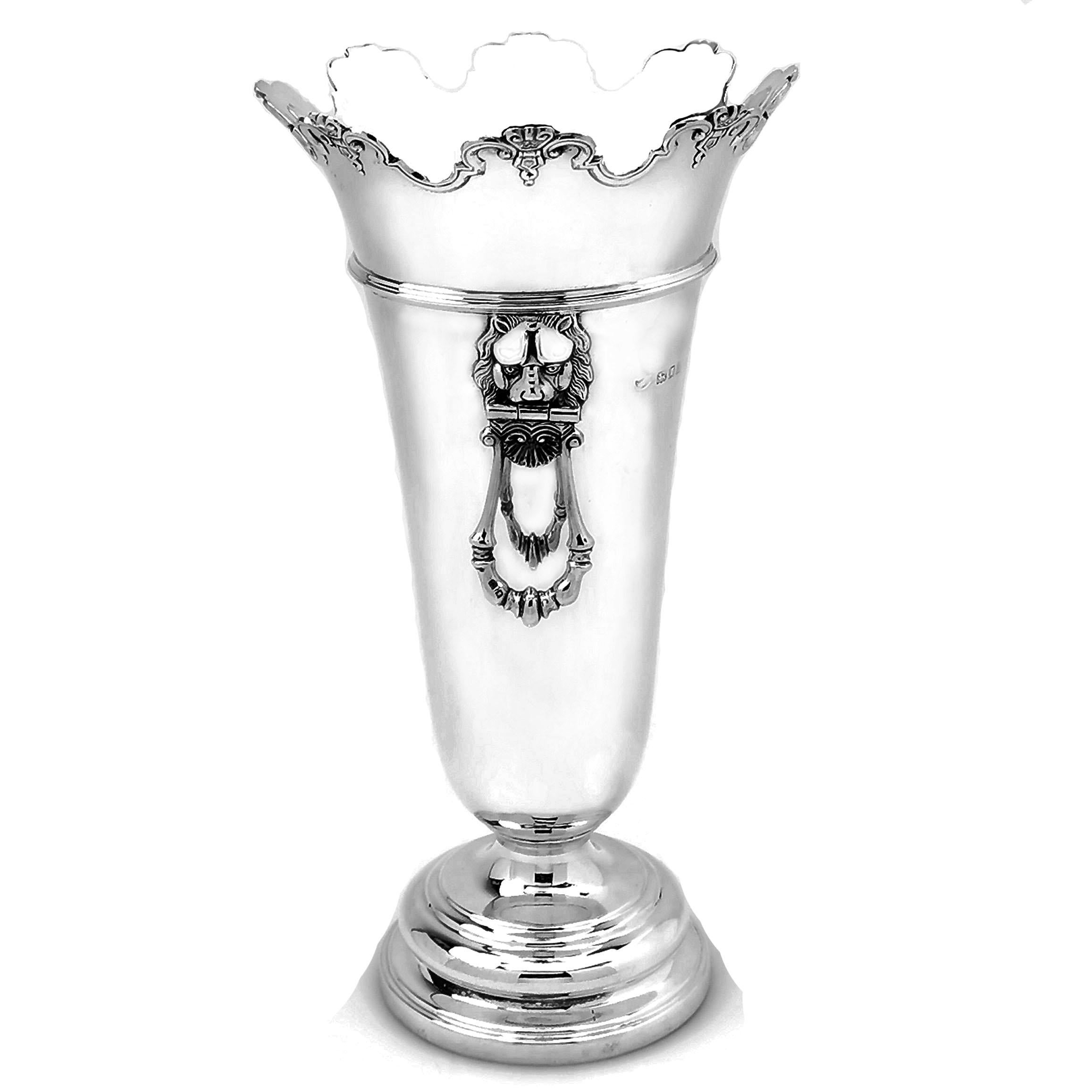 An elegant solid Silver Vase with a simple trumpet shape and standing on a spread pedestal foot. The Vase has a shaped rim and a pair of impressive lion head handles.

This Vase was made in London in 1923 by Hawksworth and Eyre. 

Approx. Weight -