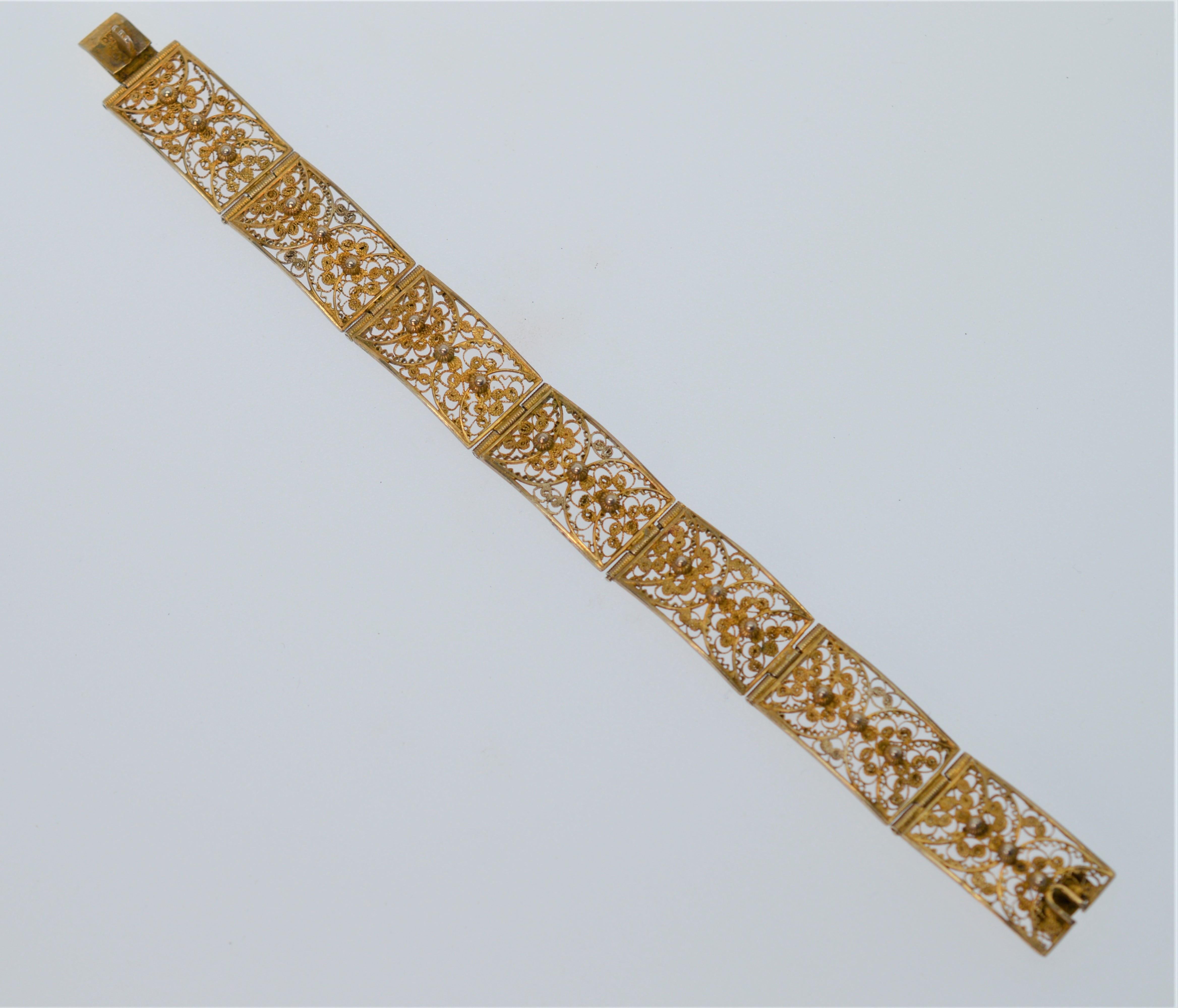Handmade in India, this seven inch bracelet is crafted of seven hinged Gold Plated Sterling Silver Links each 1 x 1/2 inch of a delicate filigree design.
Great vintage toning. Has a simple snap clasp closure. In Gift Box. 