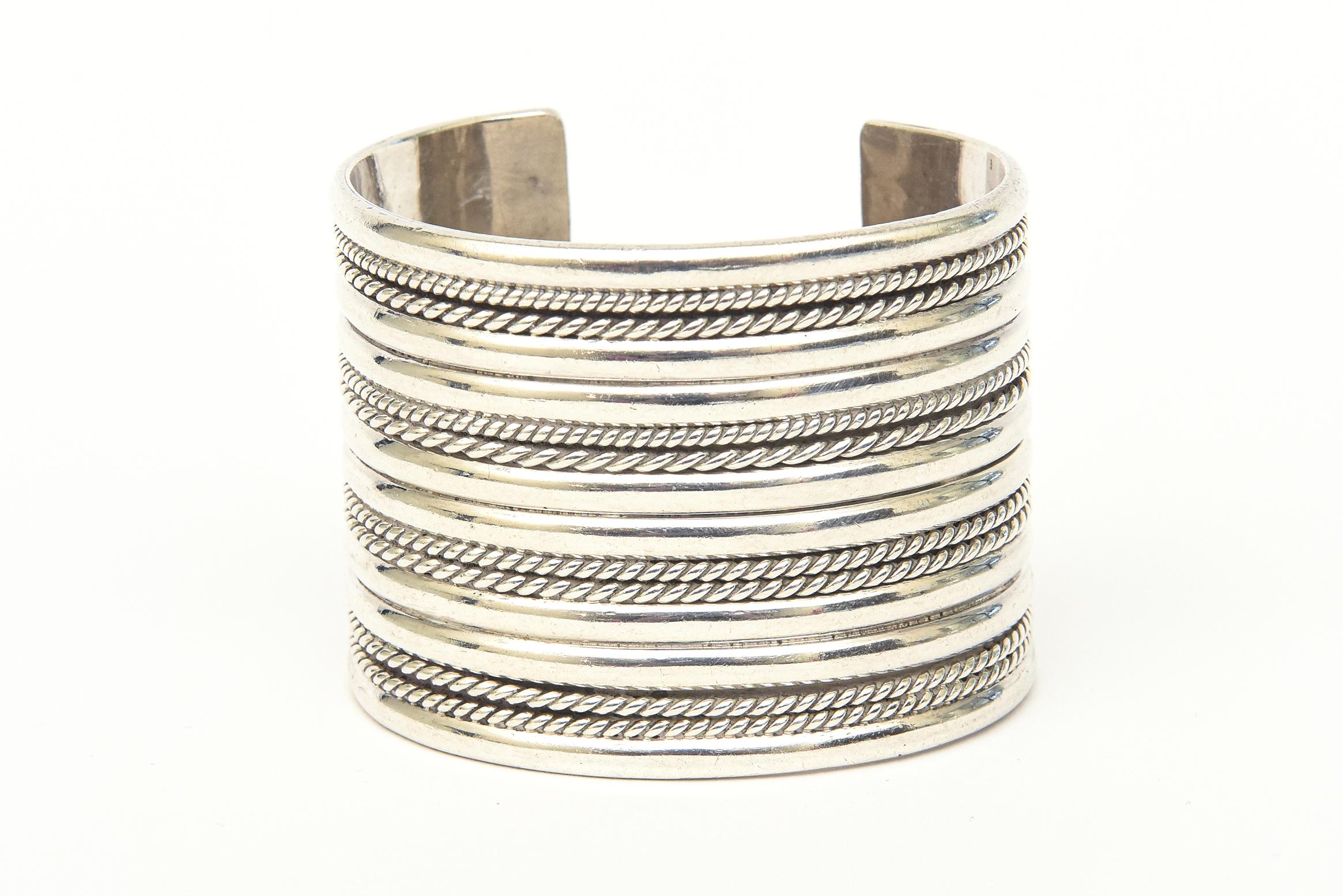 This absolutely stunning and hefty hallmarked vintage sterling silver wide cuff bracelet is a knock out. It has 4 lines / rows of angled ribbed textural designs. It is heavy gage and our favorite piece now to our collection. This is show stopper on