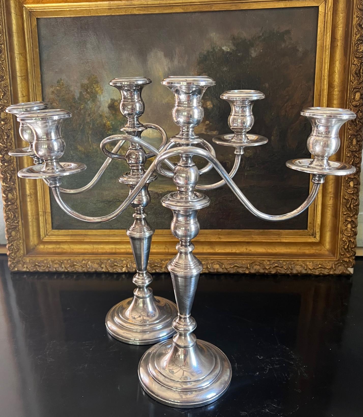 Pair of two convertible sterling weighted candelabras made in the New Jersey by the Fisher Silversmiths company in the mid 20th century. The candlesticks convert four different ways for different looks.

Each is stamped Fisher Sterling Weighted 353