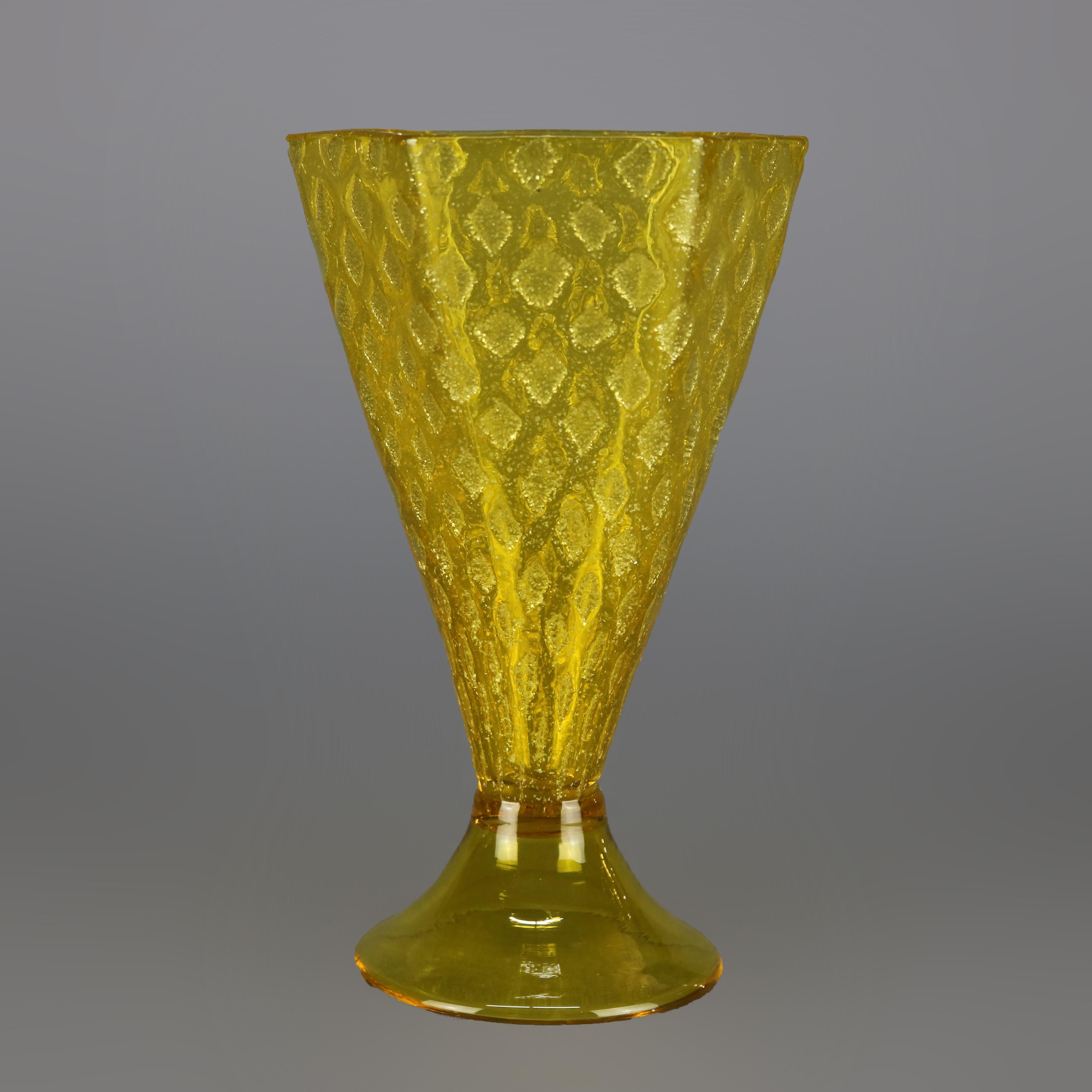 A vintage mouth blown art glass vase by Steuben offers flared and faceted form with sunflower yellow glass having repeating diamond pattern, raised on circular plinth, unsigned, 20th century

Measures: 6.75