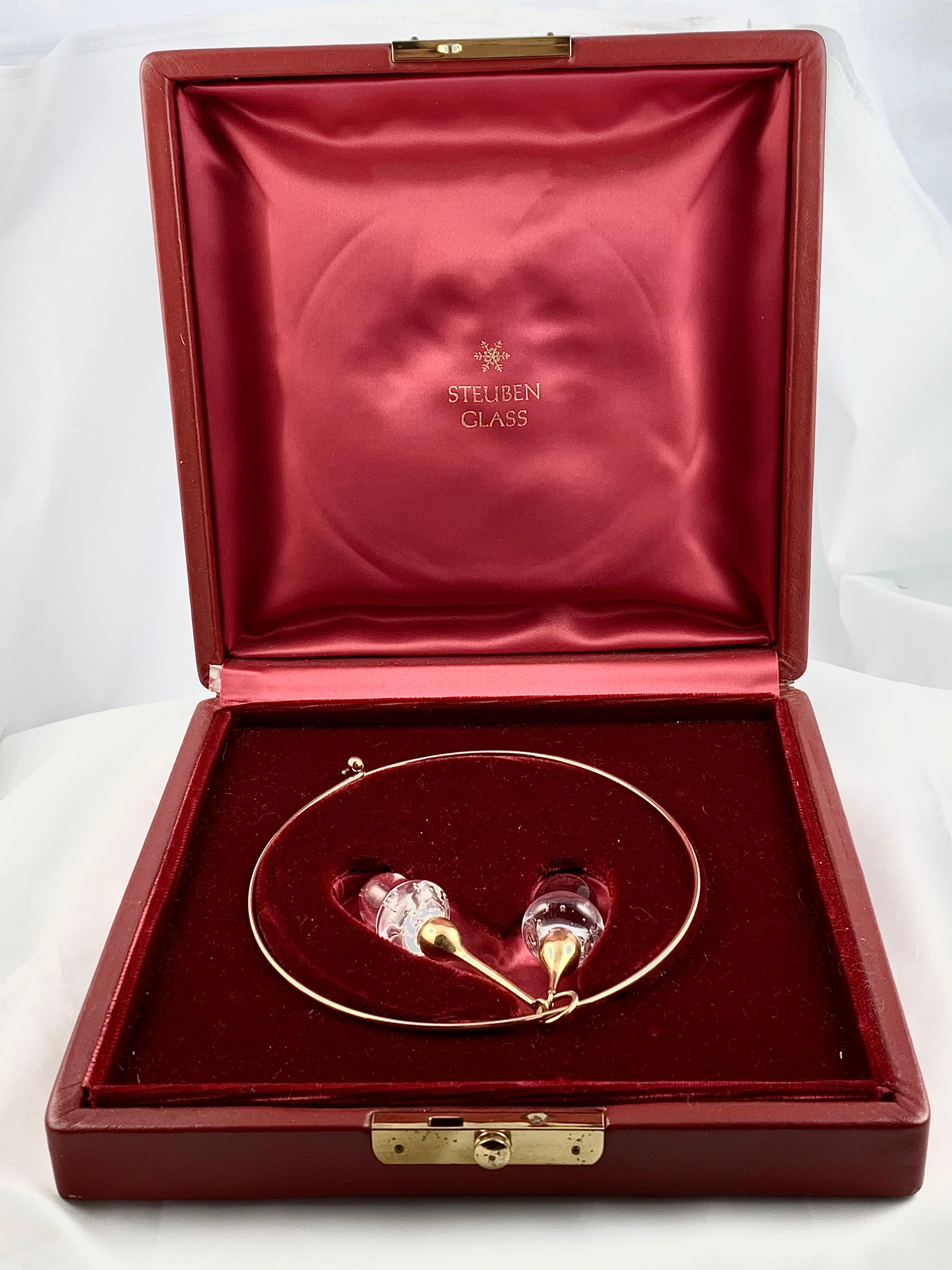Gorgeous Vintage Steuben Glass Acorn Choker Necklace in original box. The pendant features two bubble glass crystal acorns with 18K yellow Gold stars and bales. The pendant measures 3.5 inches from top to bottom (including the bale). The acorn beads