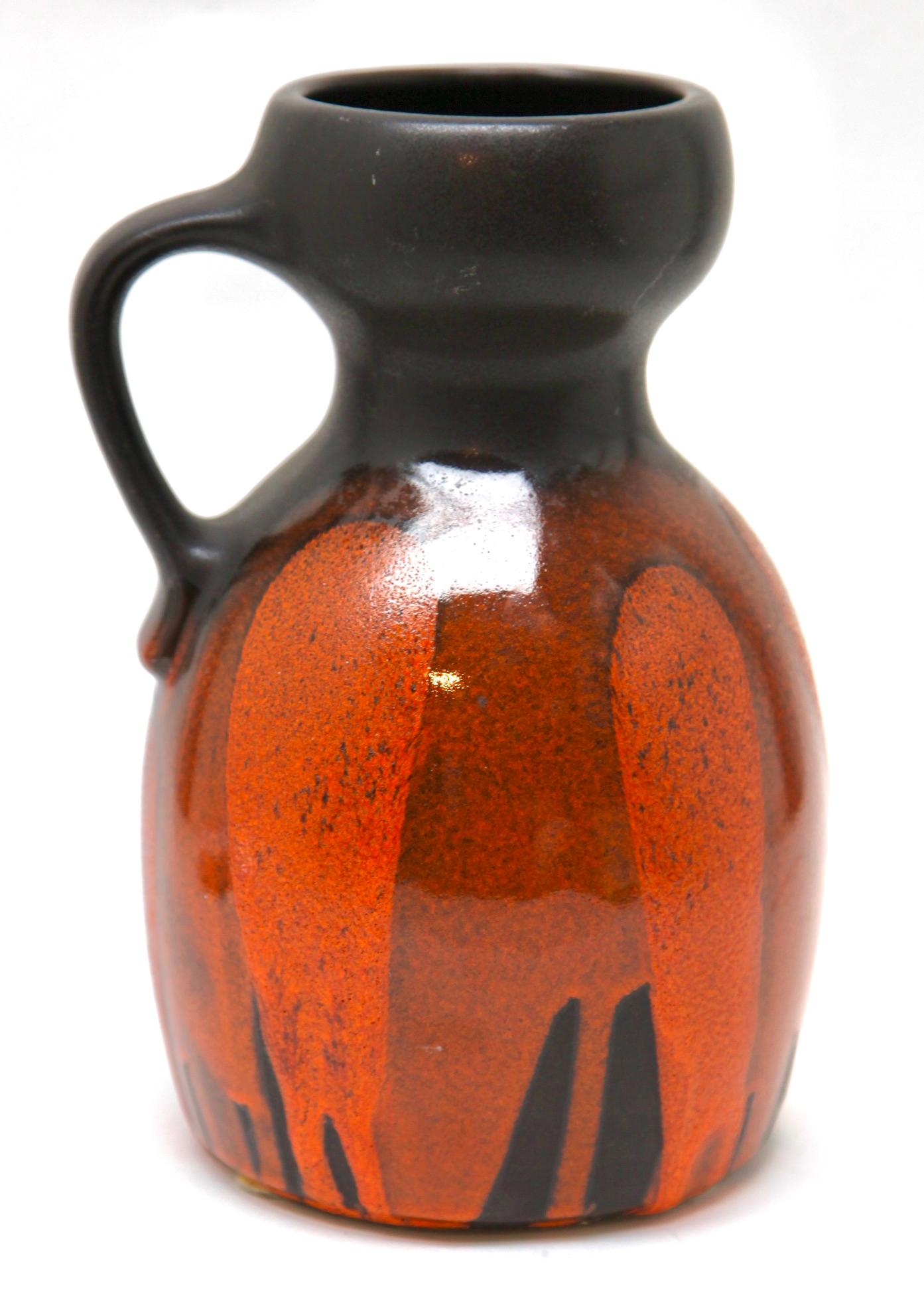 A classic 60s Steuler (Stamp) design. Of fat lava handled vase, pitcher in the classic sixties decor; with a rough glaze of dark earth-colour over the Cobalt 
W-Germany. 
Hand decorated glaze.
Stunning color.

