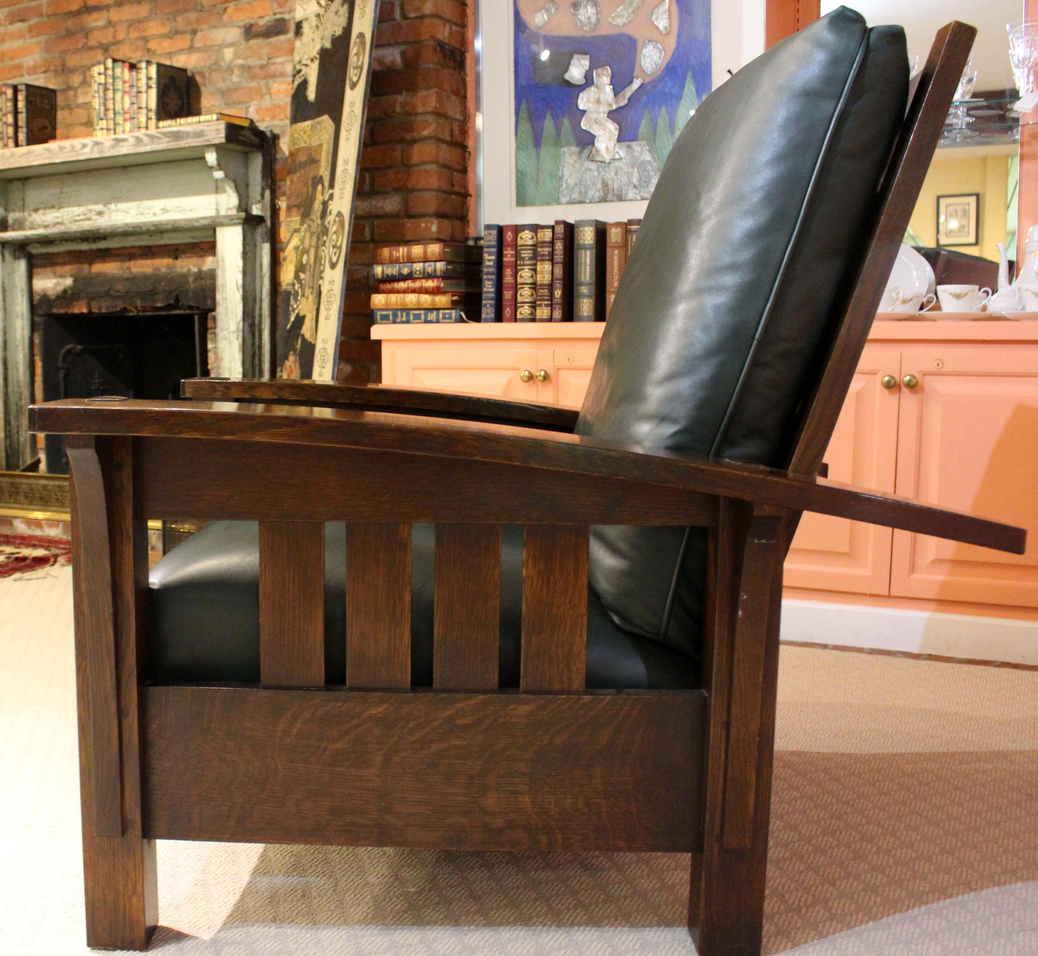 Vintage Stickley oak & blue-green leather Morris chair. The heavy oak pegs adjust to recline the chair to 4 positions. Superb craftsmanship. Bowed arms, wide enough to support a glass comfortably. Great figure in the solid oak. Stickley label,