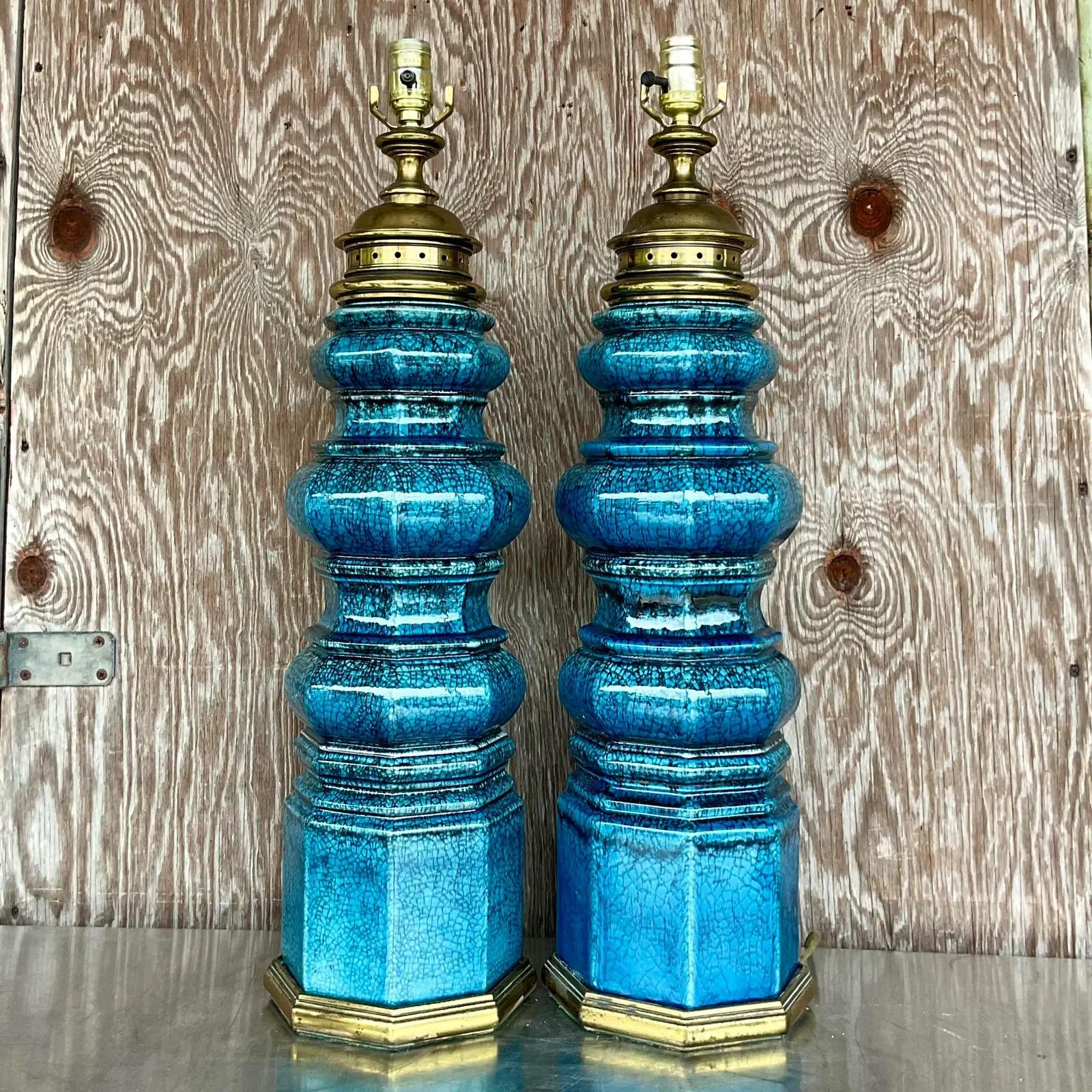A gorgeous pair of large vintage blue crackle glazed ceramic totem/pagoda lamps with satin brass hardware. Acquired at a Palm Beach estate.