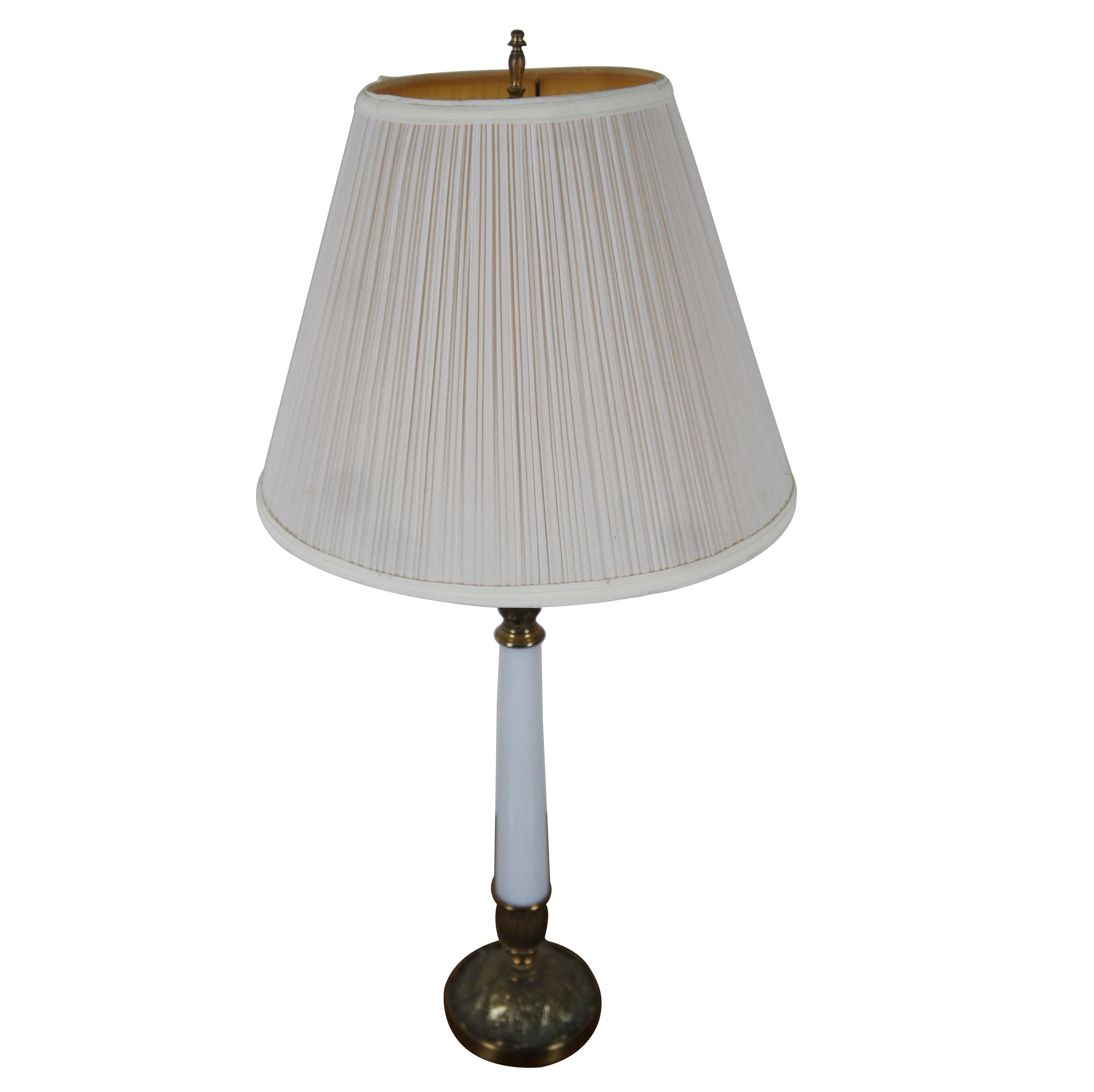 Vintage midcentury Stiffel brass and white porcelain candlestick shaped, Hollywood Regency style table lamp. Includes a simple pleated shade.

Measures: 5” x 23” / Shade - 14” x 10.5” / Total Height – 30” (Diameter x Height).