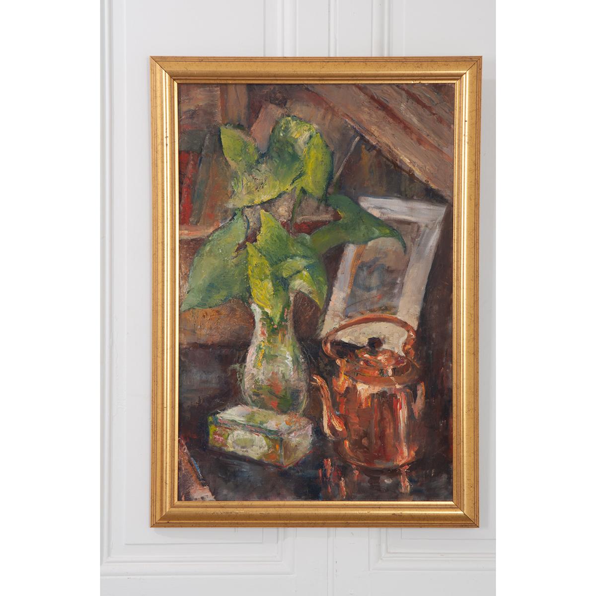 A vintage still life painting of a vase with green foliage, a copper tea kettle, and a book. It is framed in a vintage gold gilt frame.