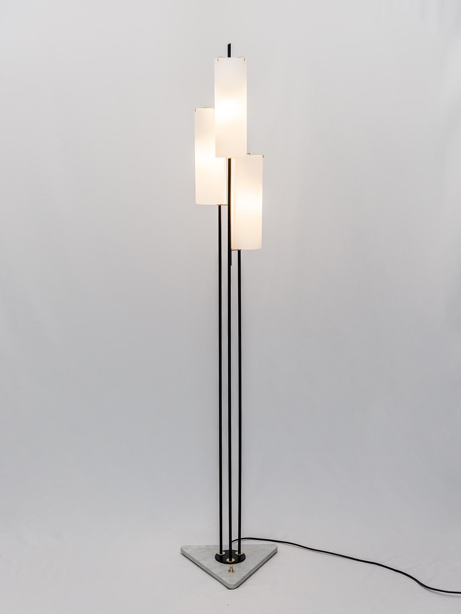 Stunning tall floor lamp by Stilnovo. The three cascading milky glass shades emit a soft ambient light and are held by beautifully crafted brass fixtures. A brass light switch is integrated in the triangular Carrara marble base. Made in Italy, circa