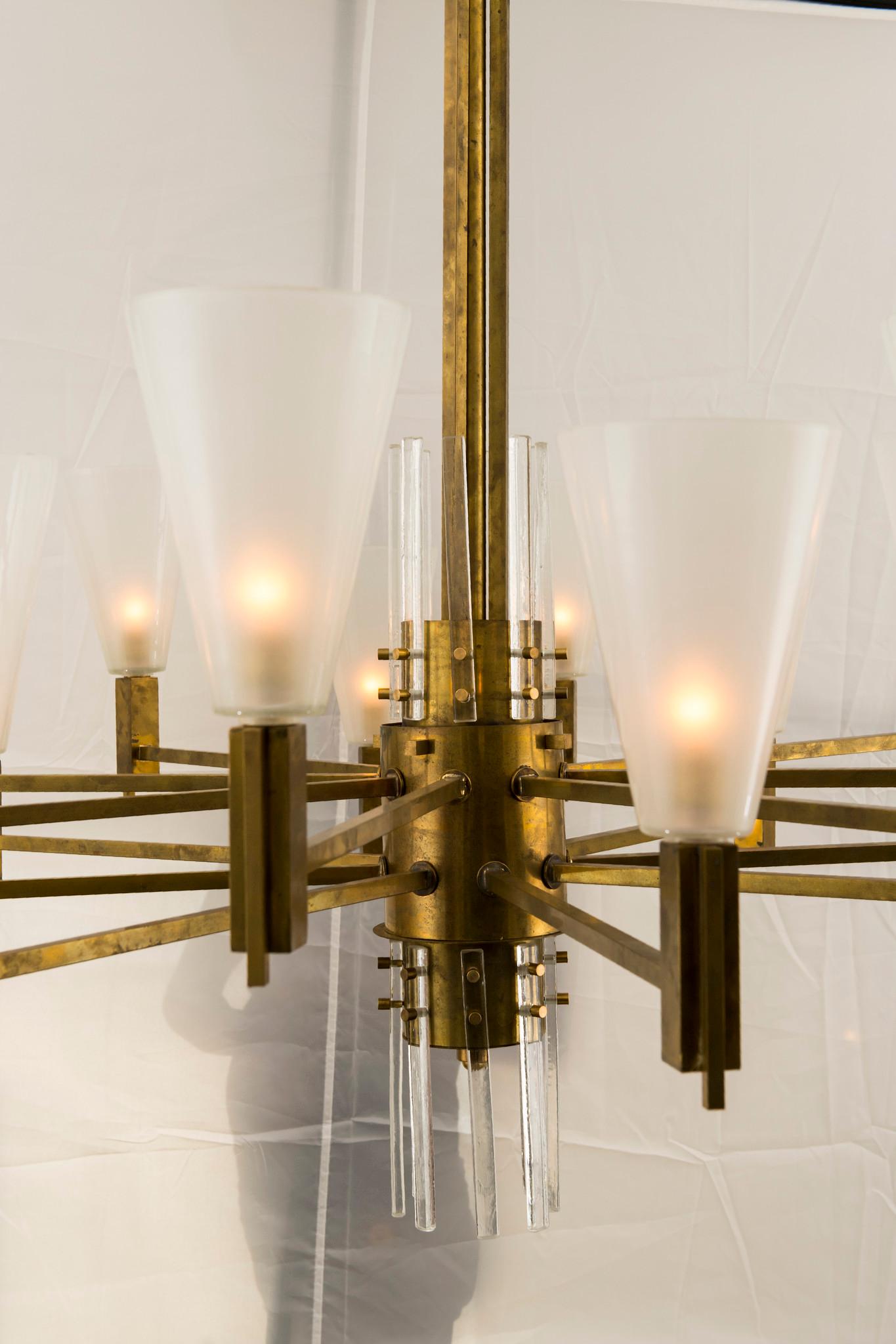 A massive and handsome vintage Stilnovo style 16 light solid brass and glass chandelier from Milan, newly electrified.