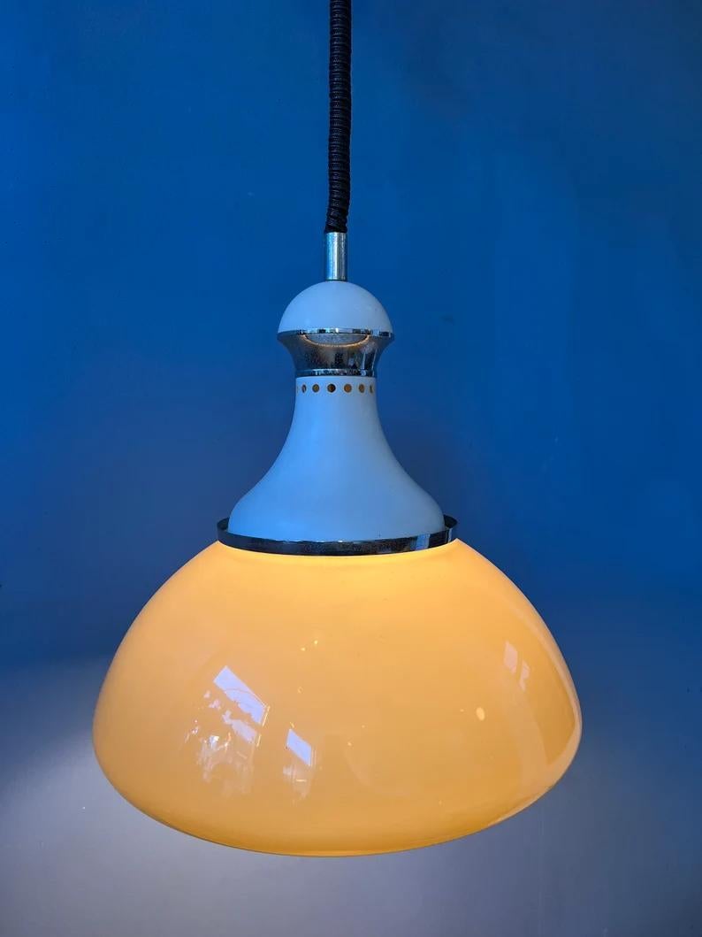 Mid century Stilux Milano pendant lamp with beige acrylic glass shade. The height of the lamp can be adjusted with the rise-and-fall system. The lamp requires one E27 (E26 in the US) lightbulb. The lamp is hardwired for 110v - 230v.

Additional