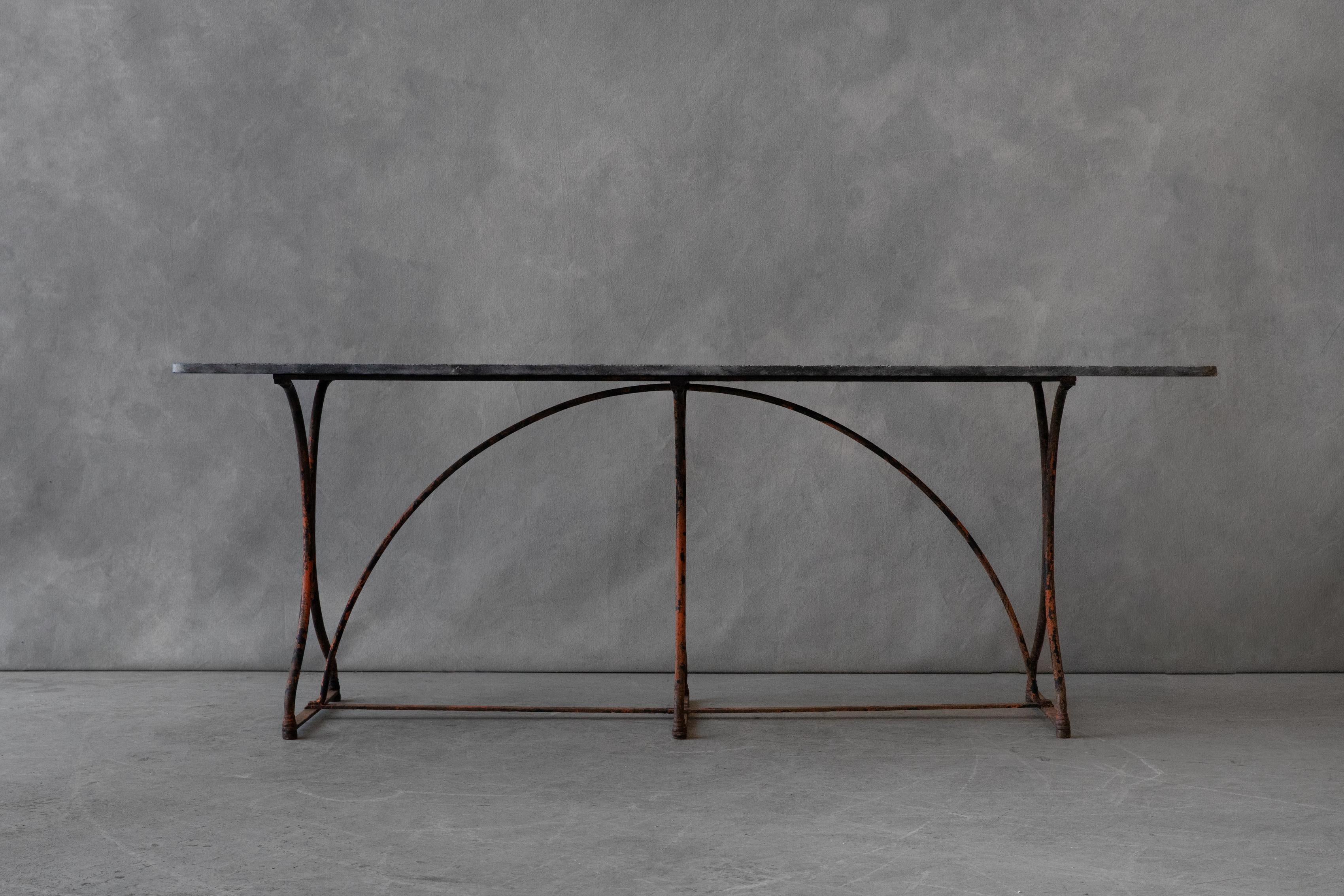 Vintage stone bistro table From France, circa 1950. Bluestone top on a steel base with fantastic original color. 


