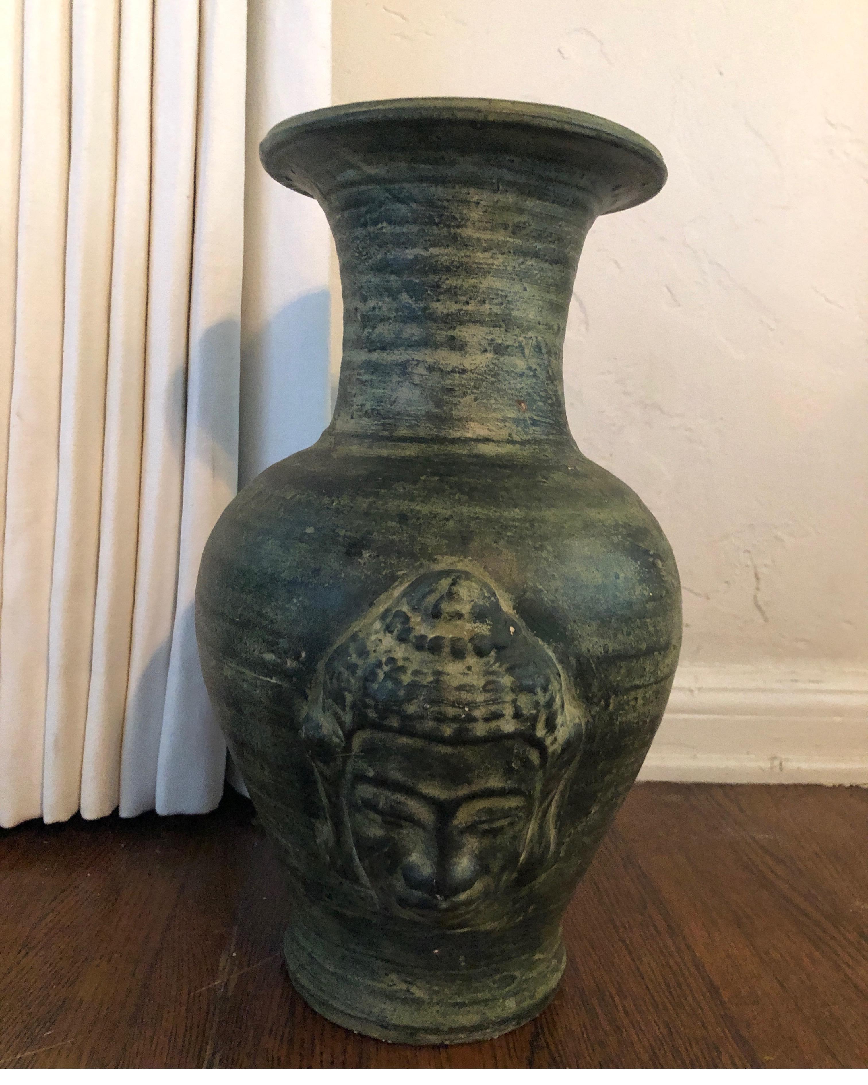 Buddhist urn/vase.
Green patina with face on both sides of urn.
Measures: Height 17.5 x 14” x 8.5” at the opening.