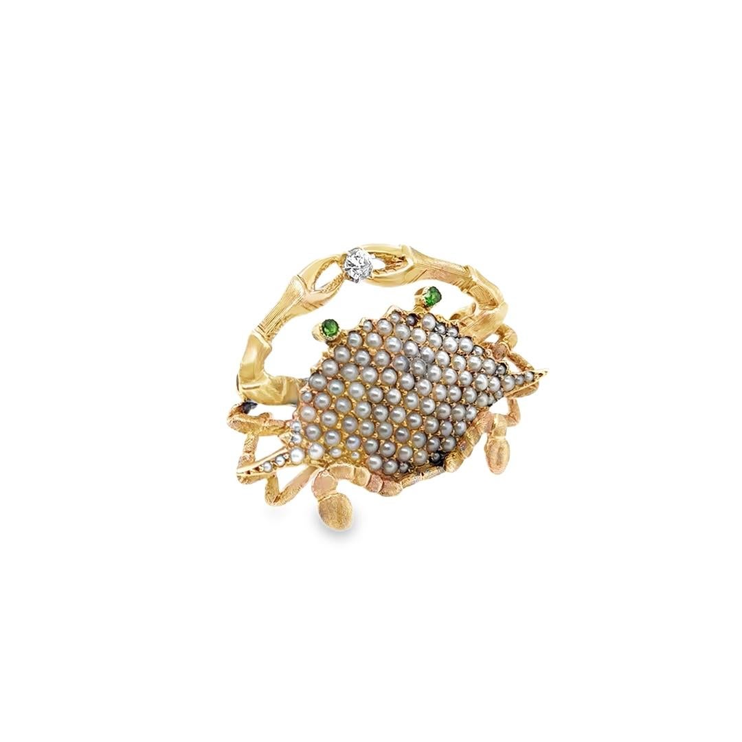 Beautiful life like creation crafted in 18k yellow gold. The brooch also has a bale and can be worn as a pendant. The brooch depicts a life like stone crab with gemstones set throughout! The body section of the crab is set with natural pearl