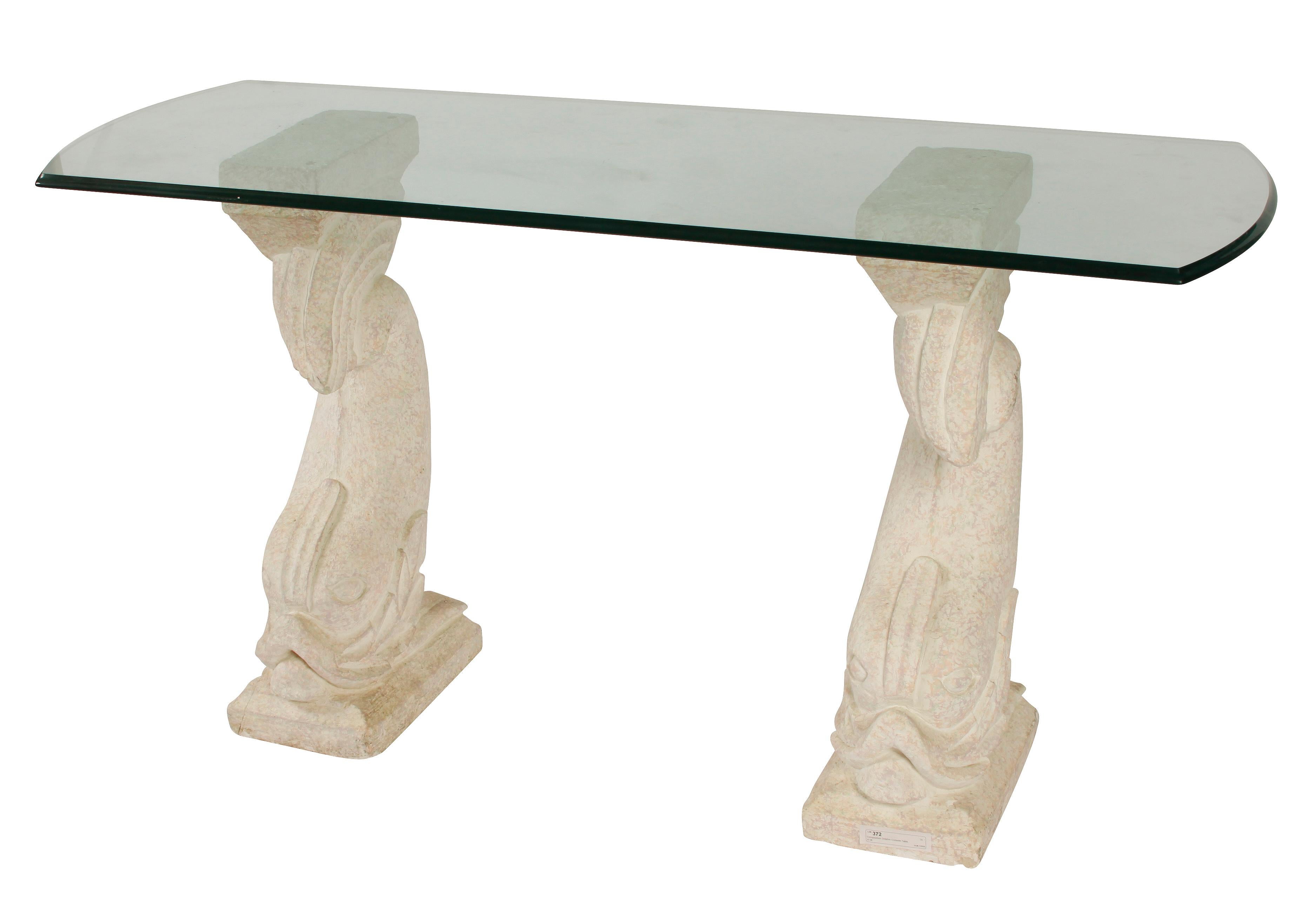 Vintage stone dolphin table with glass top.