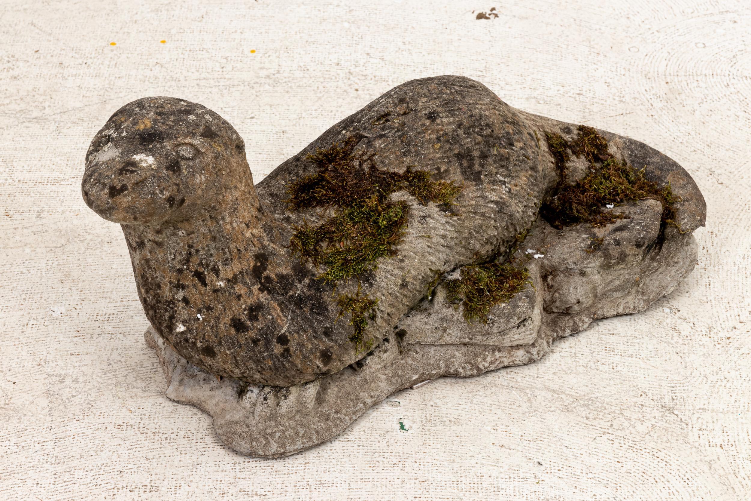 Circa early 20th century vintage cast stone garden ornament in the shape of an Otter. The piece features detail with designed patina. Please note of wear consistent with age.