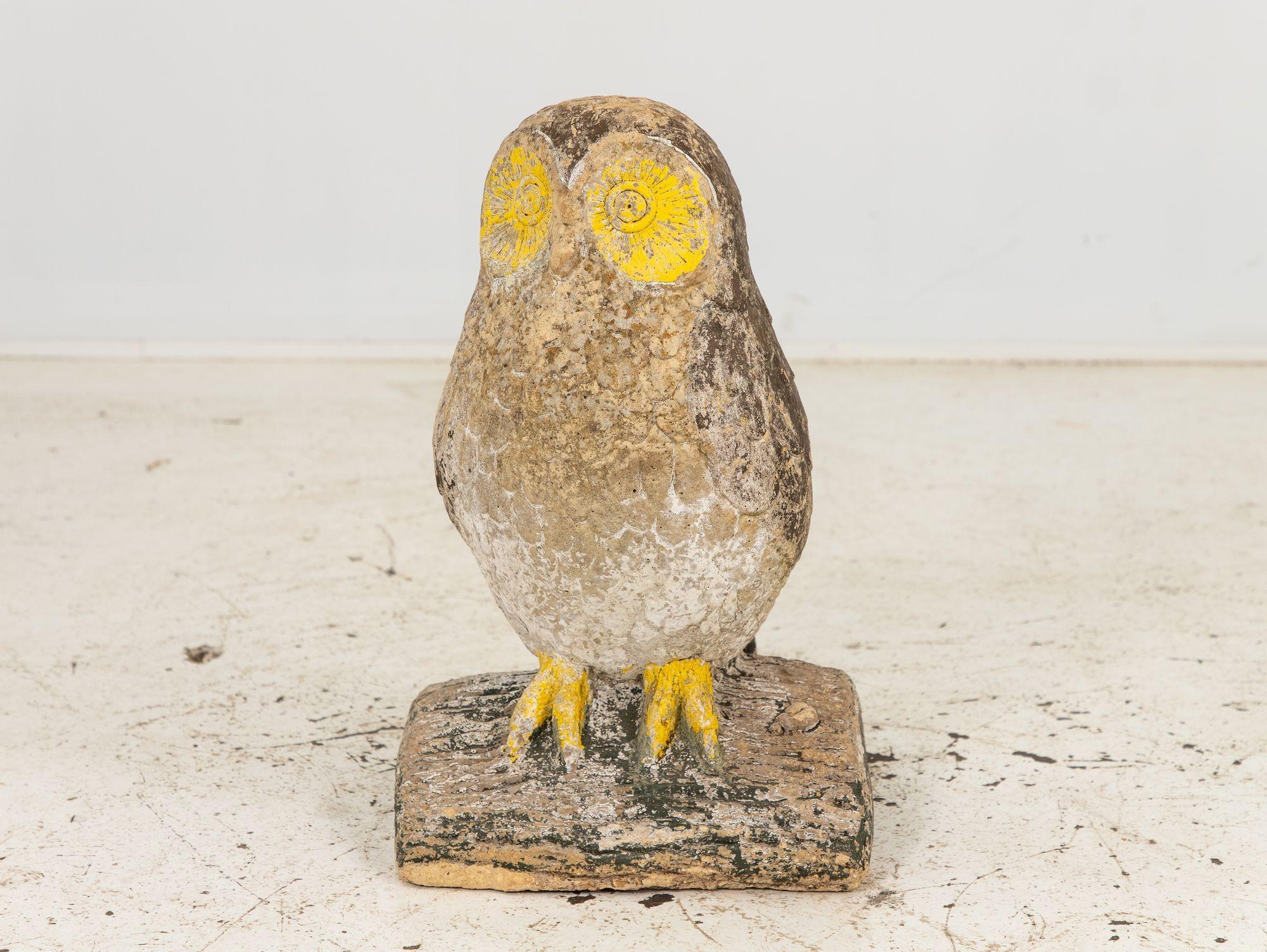 This early 20th-century French cast stone owl, gracefully perched upon a split log, stands as a captivating garden ornament. Its exquisite craftsmanship showcases intricate detailing around the eyes and feathers, which adds a touch of enchantment to